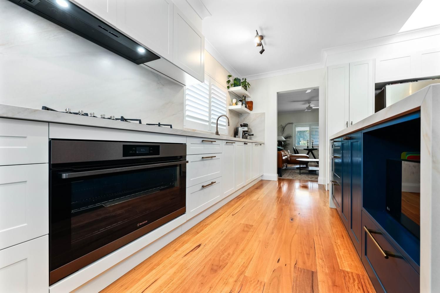Bright Modern Kitchen With White Cabinets — Above & Beyond Interiors in Smeaton Grange, NSW