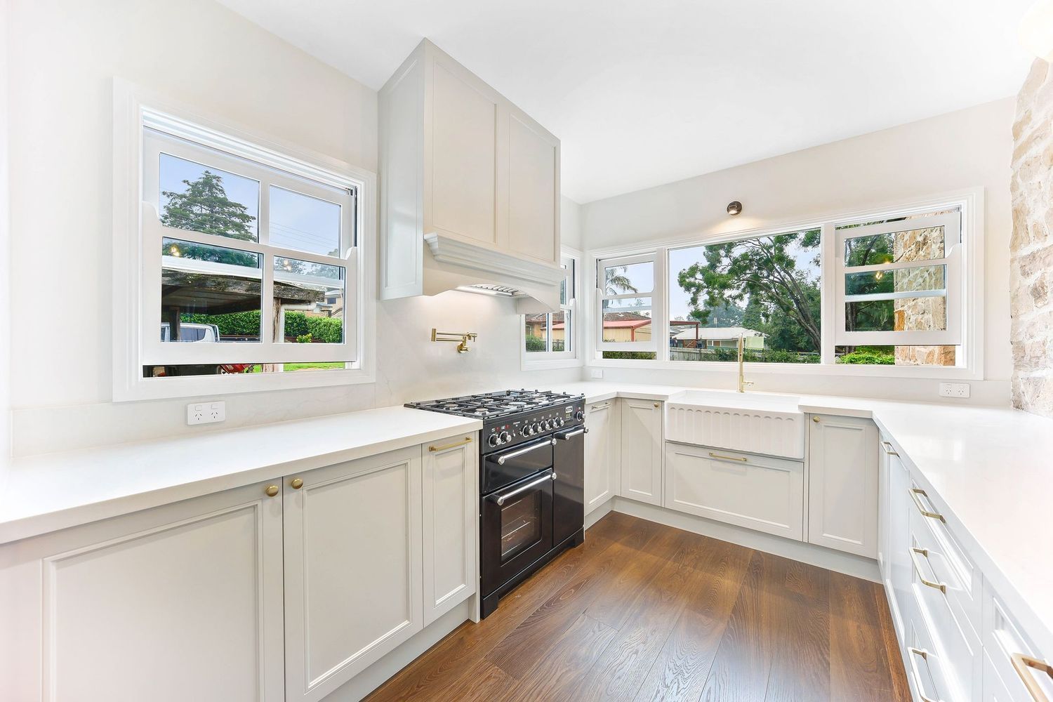 Bright White Kitchen With Large Windows — Above & Beyond Interiors in Smeaton Grange, NSW