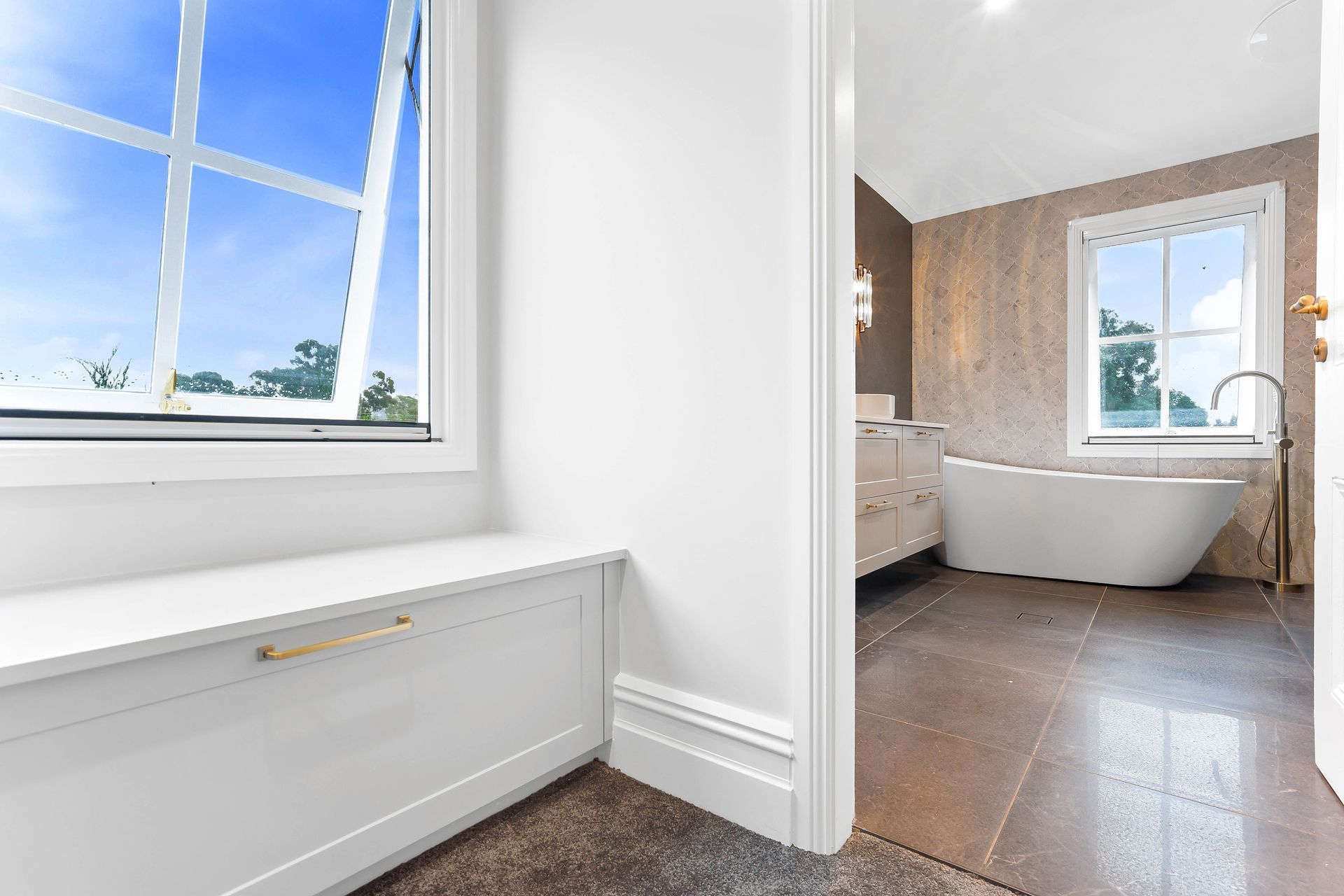 Bright Bathroom With White Tub, Tiled Floor — Above & Beyond Interiors in Smeaton Grange, NSW