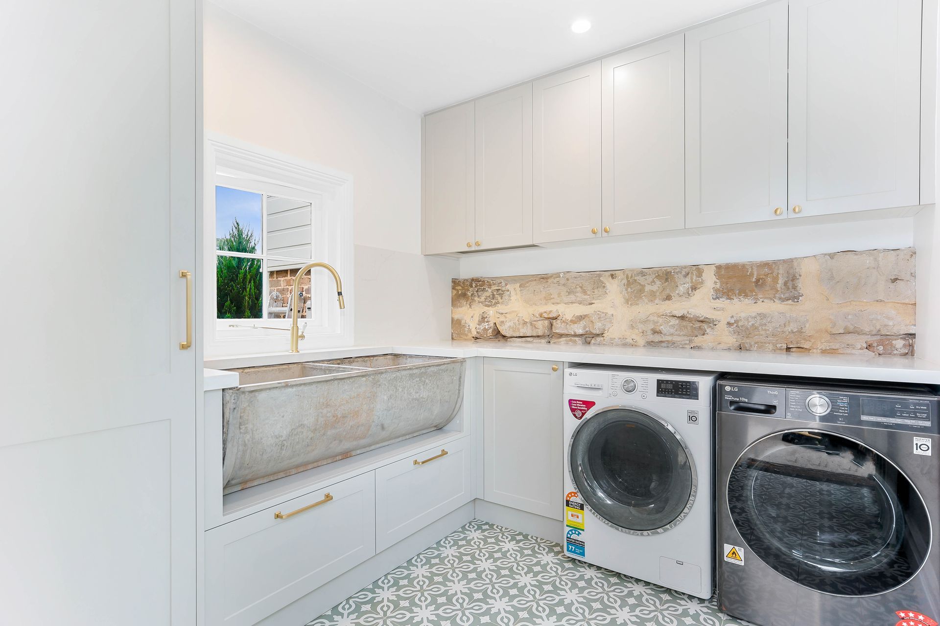 Bright Modern Laundry Room With White Cabinets — Above & Beyond Interiors in Smeaton Grange, NSW