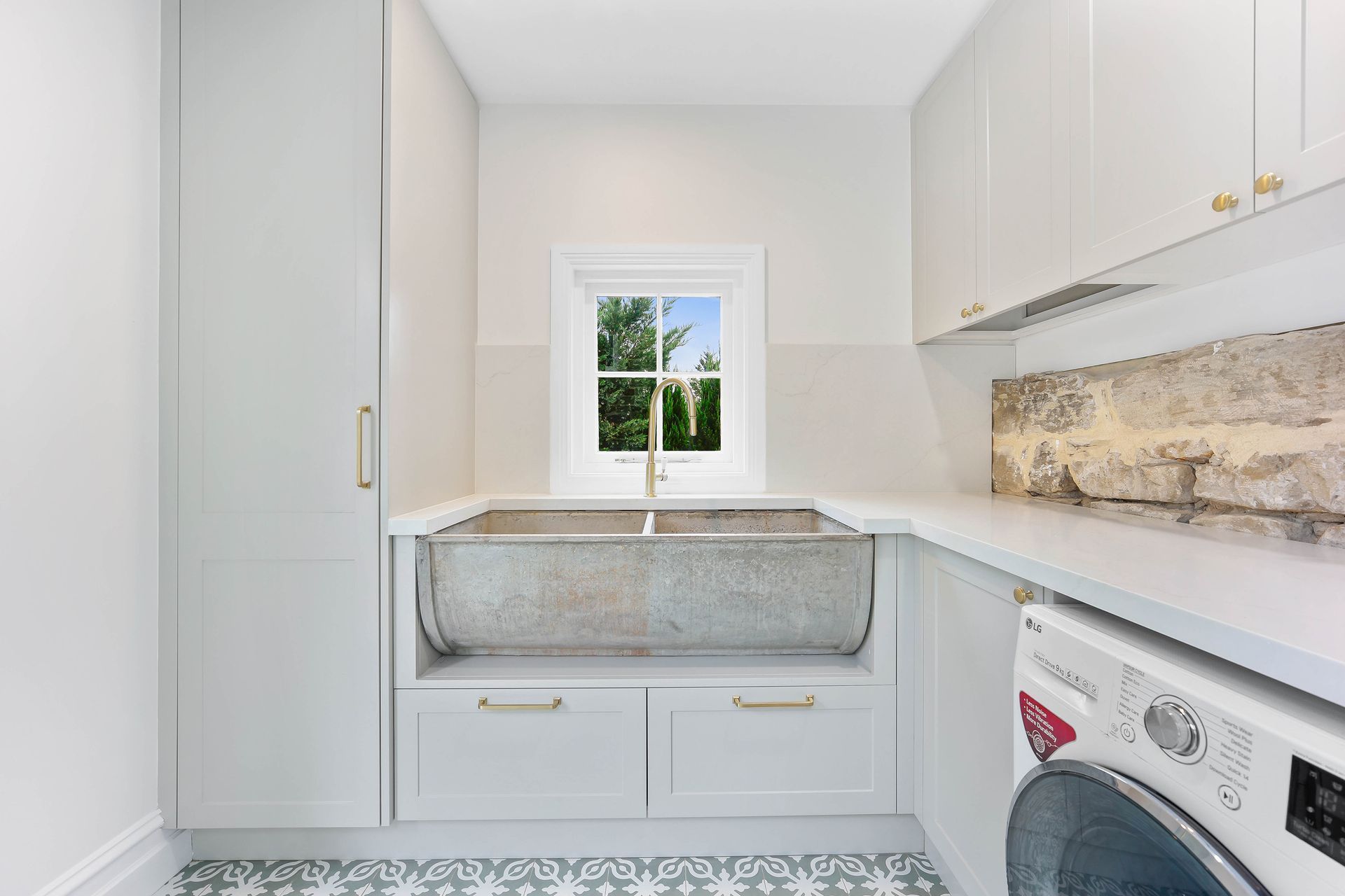 Bright Laundry Room With White Cabinets — Above & Beyond Interiors in Smeaton Grange, NSW