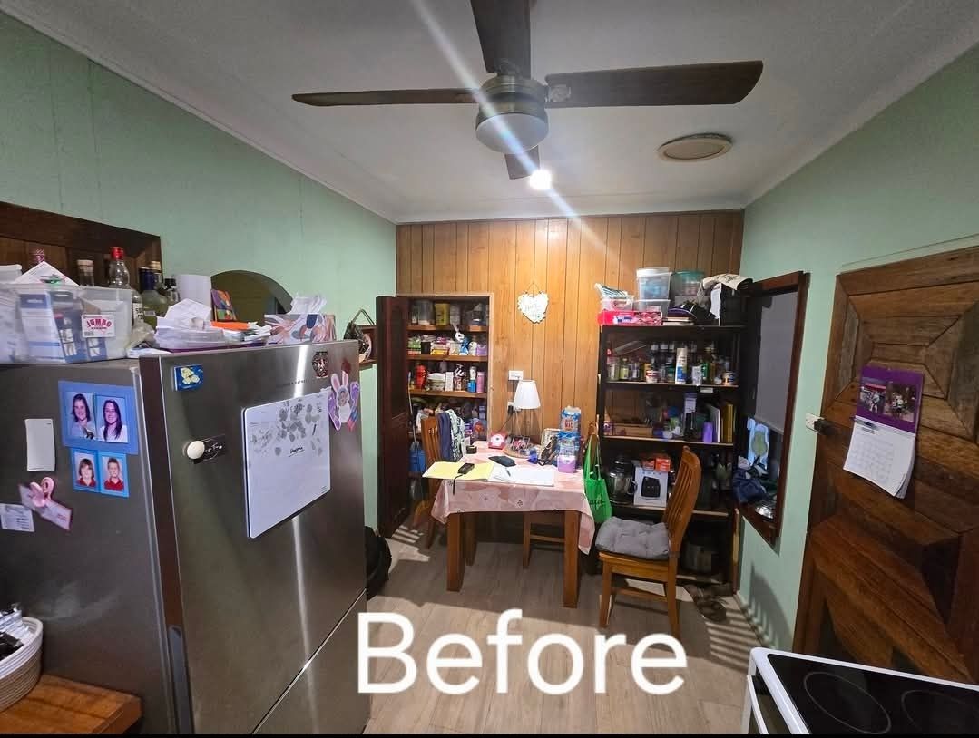 Cluttered Kitchen Before Renovation, with Stainless Steel Fridge — Above & Beyond Interiors in Smeaton Grange, NSW