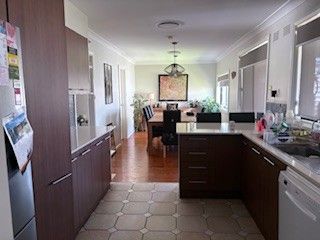 Bright, Modern Kitchen with Dark Wood Cabinets — Above & Beyond Interiors in Smeaton Grange, NSW