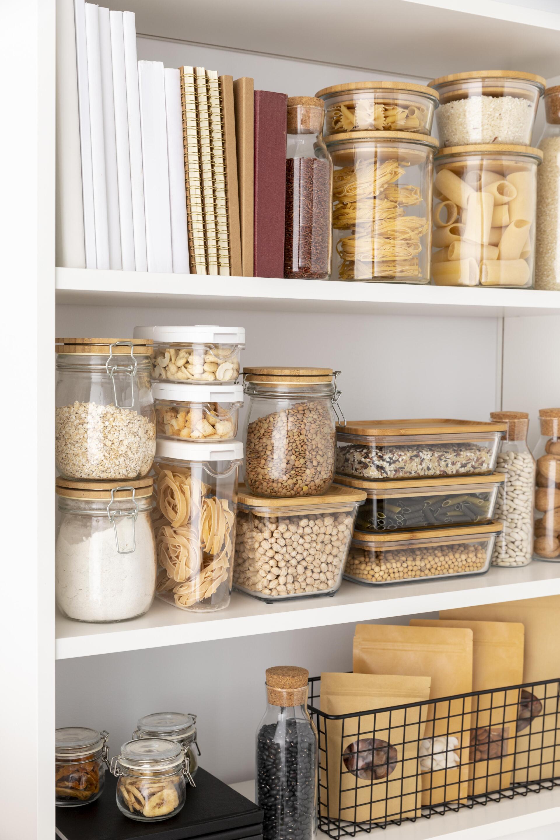 A pantry filled with jars , containers , and books.