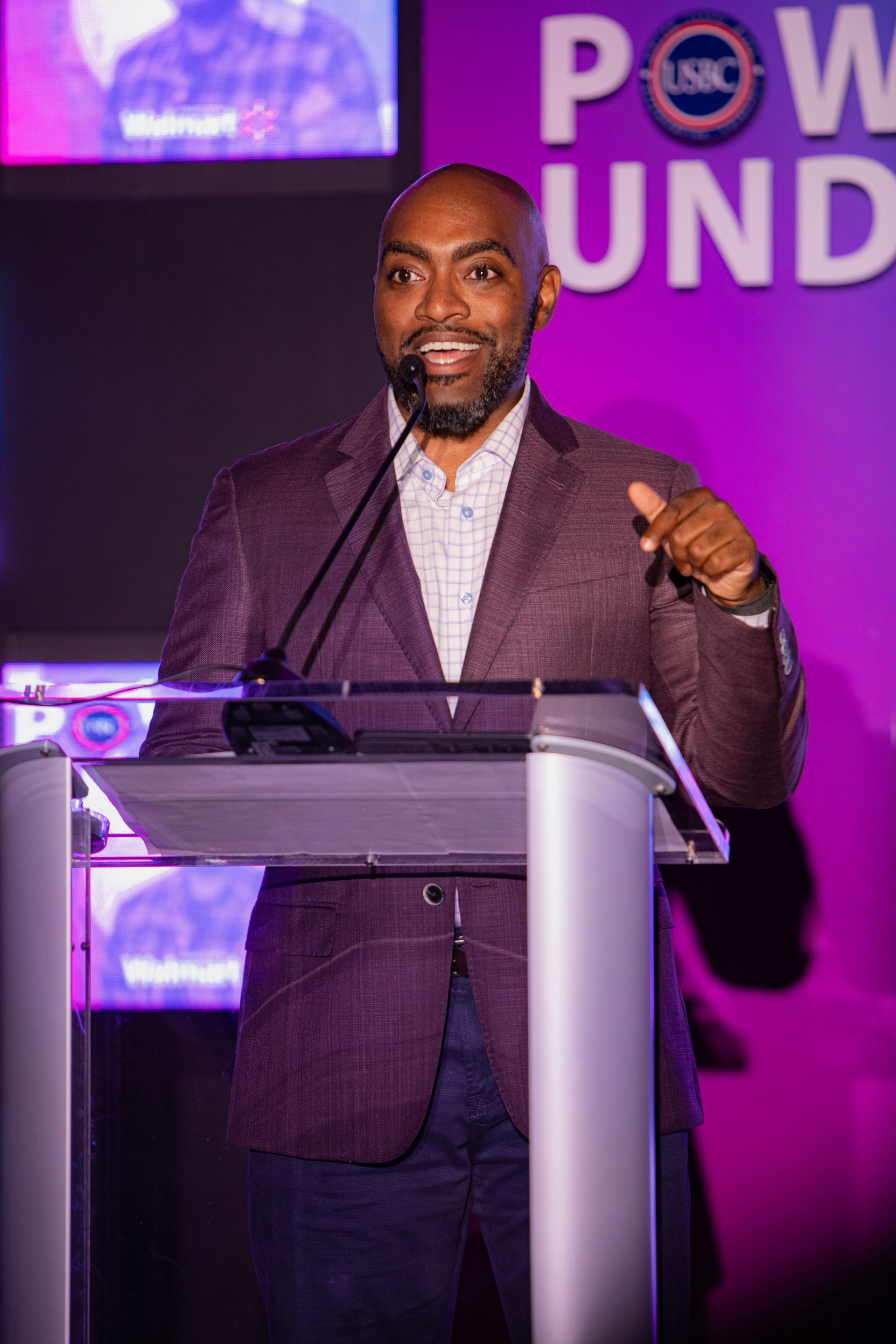 A man is standing at a podium giving a speech.