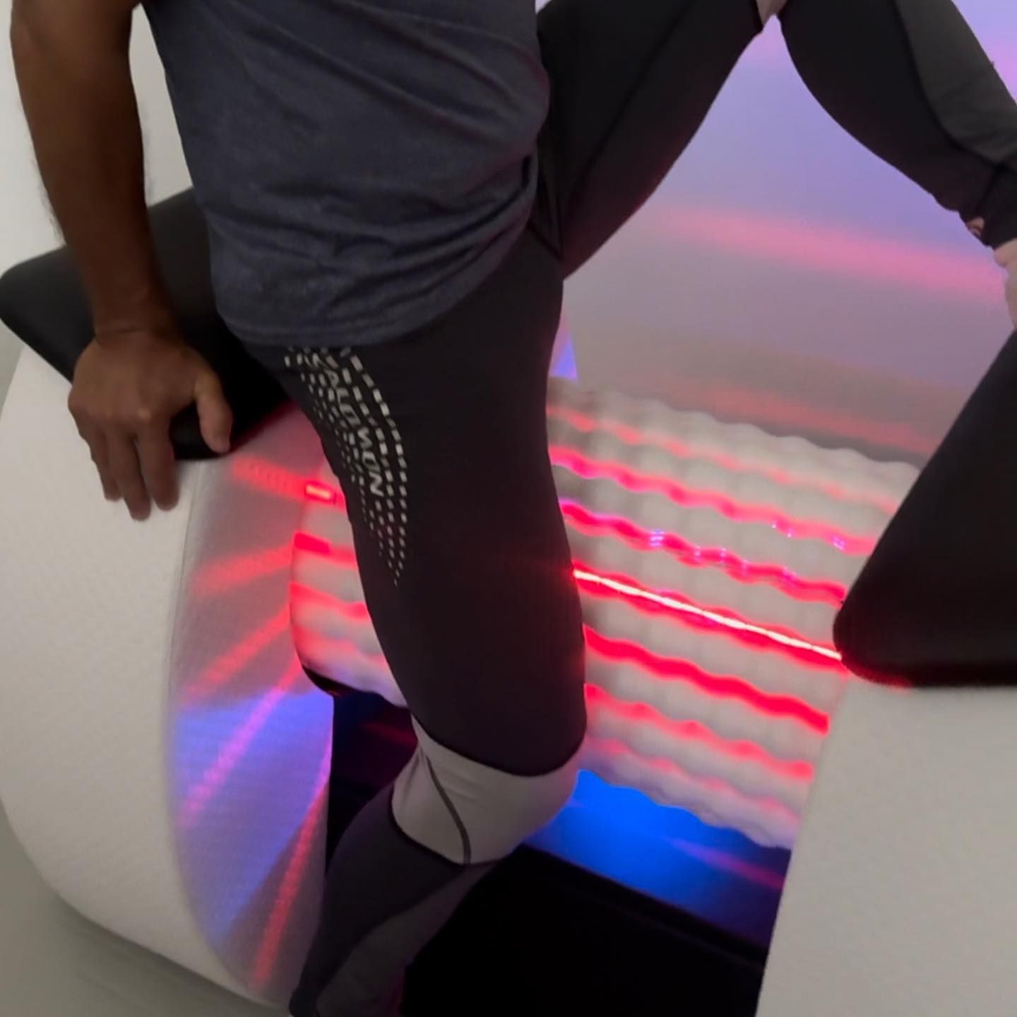 A Person Sitting on a Chair with a red light Behind them โ The Colonic Coach in Rosslea, QLD