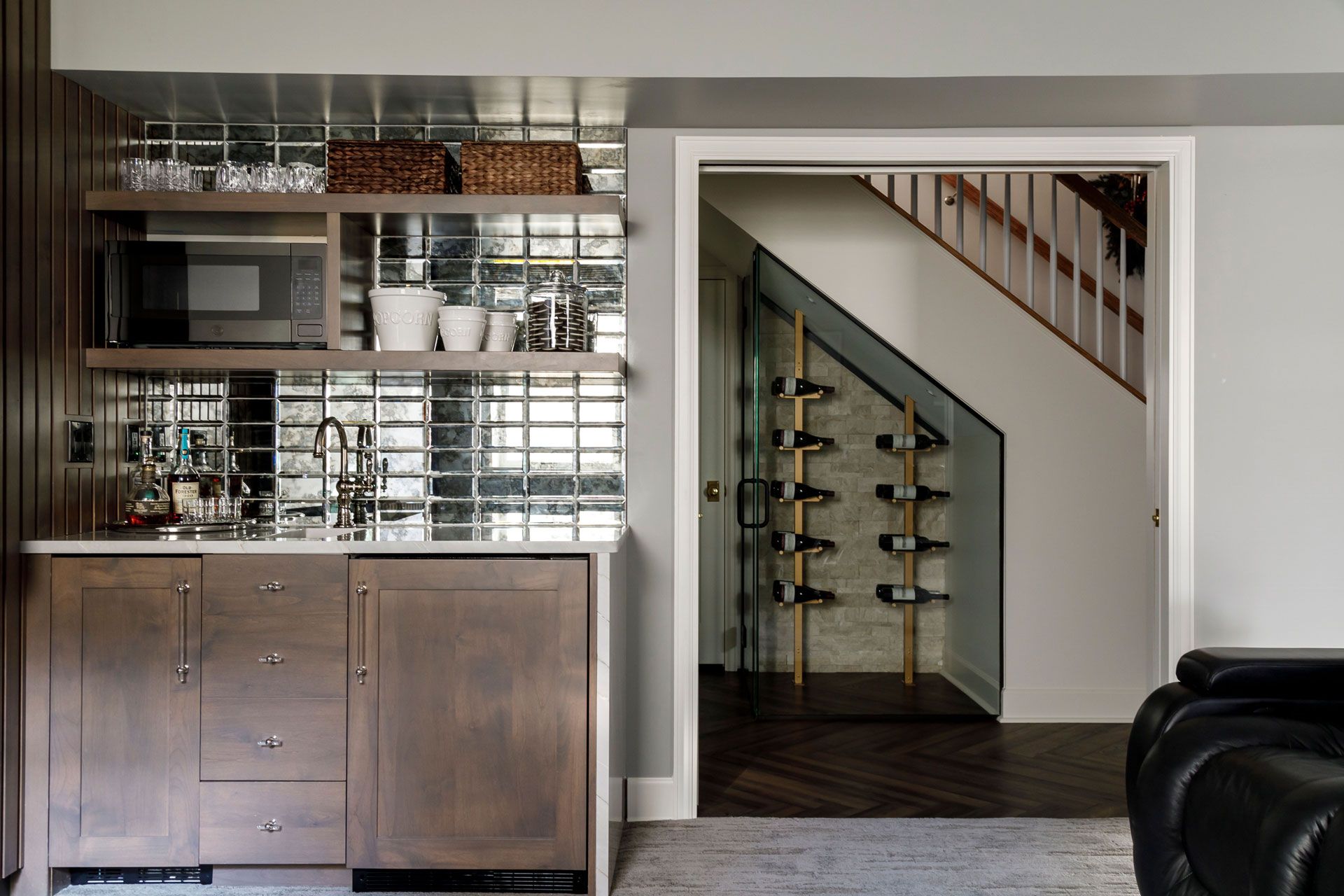 Modern home theater with a large projection screen, wood slat wall, and built-in bar cabinet