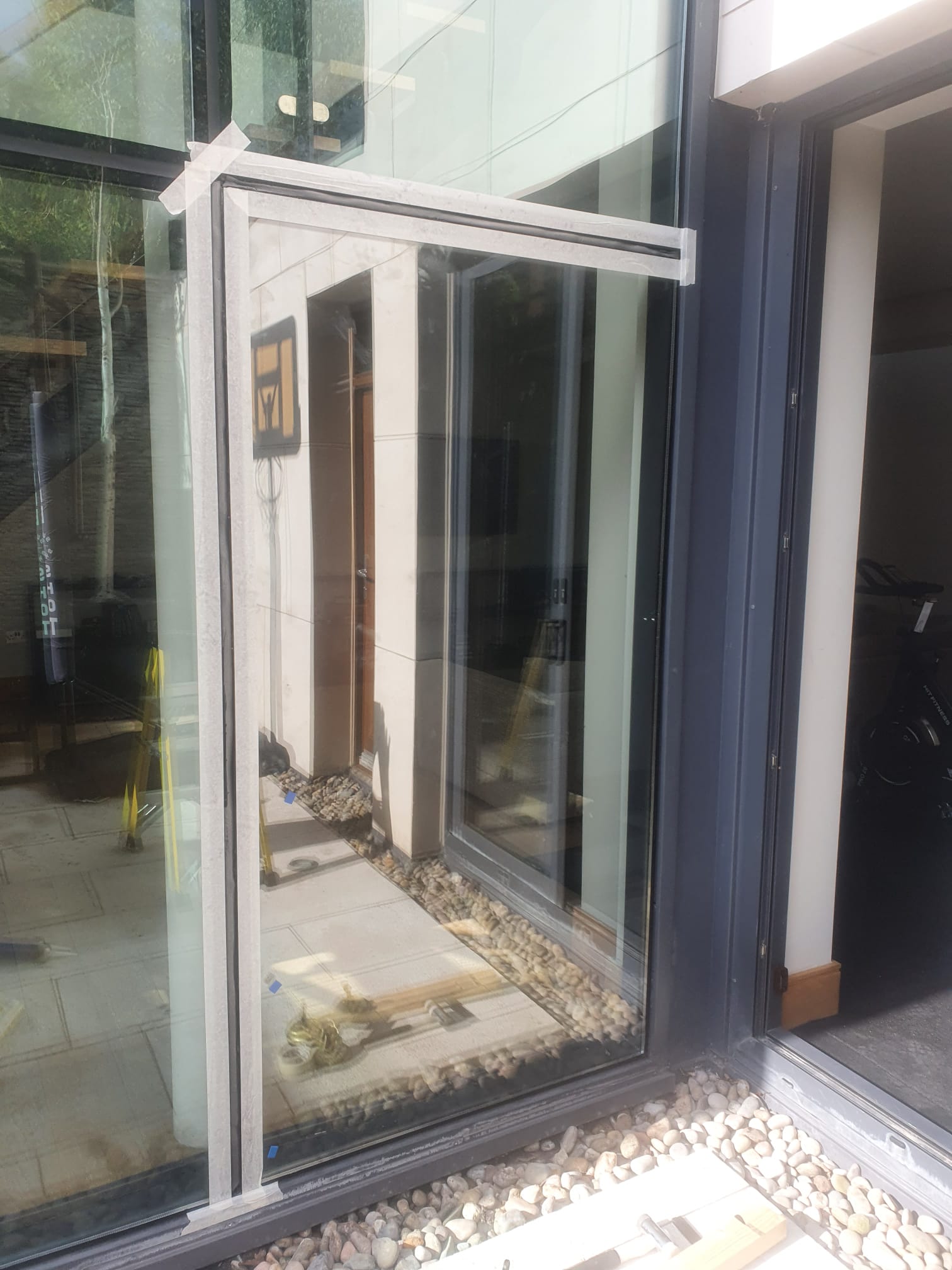 A large window with a reflection of a building in it.