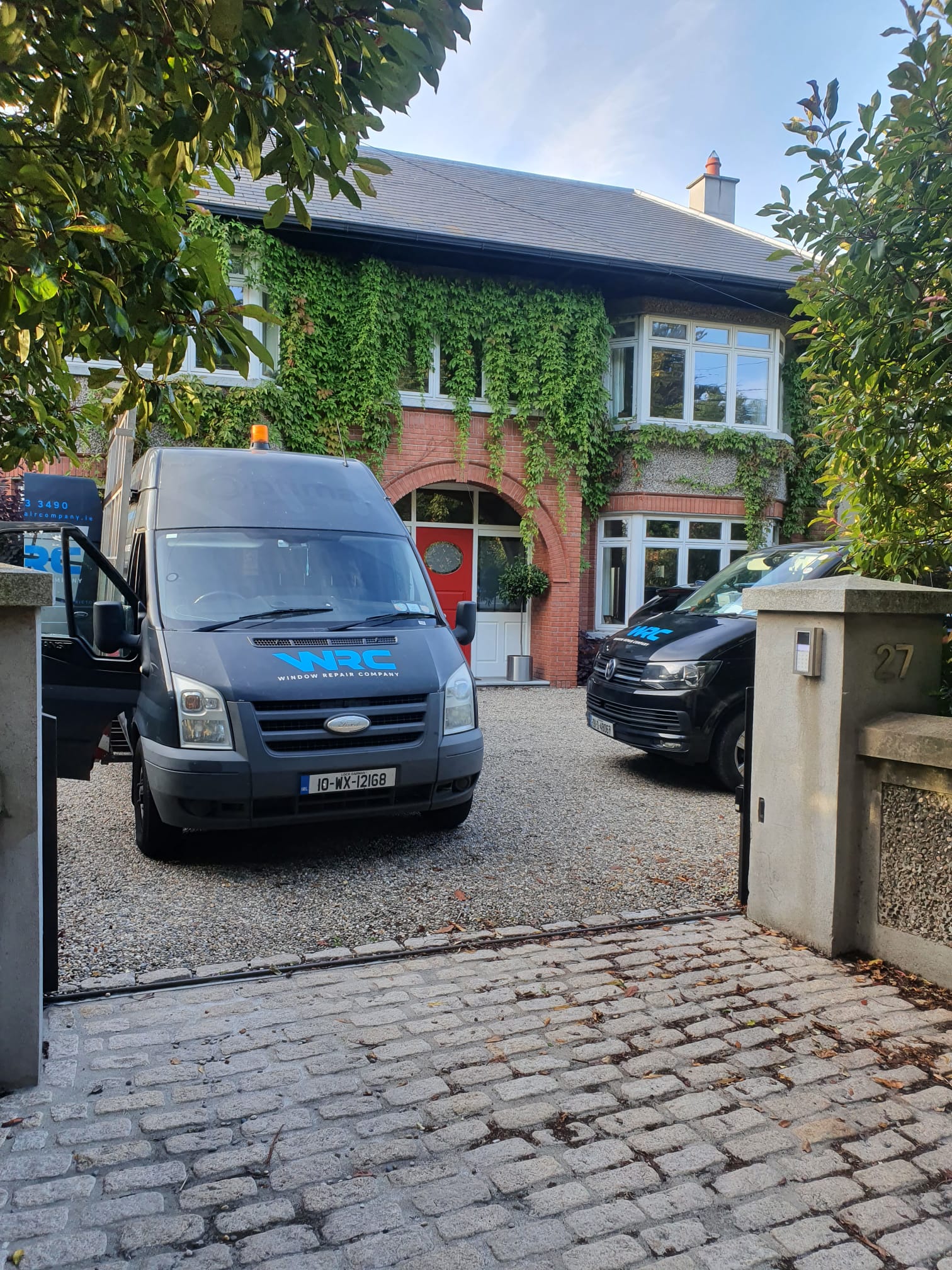 A van is parked in front of a house.