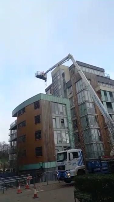 A large building with a crane on top of it.