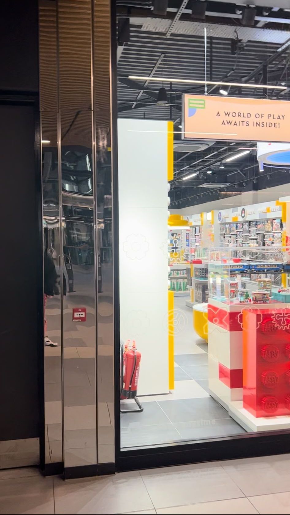 A store front with a reflection of a person in the window.