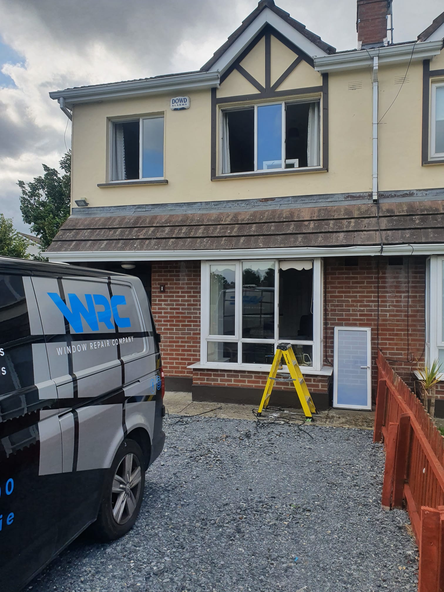 A wrc van is parked in front of a house