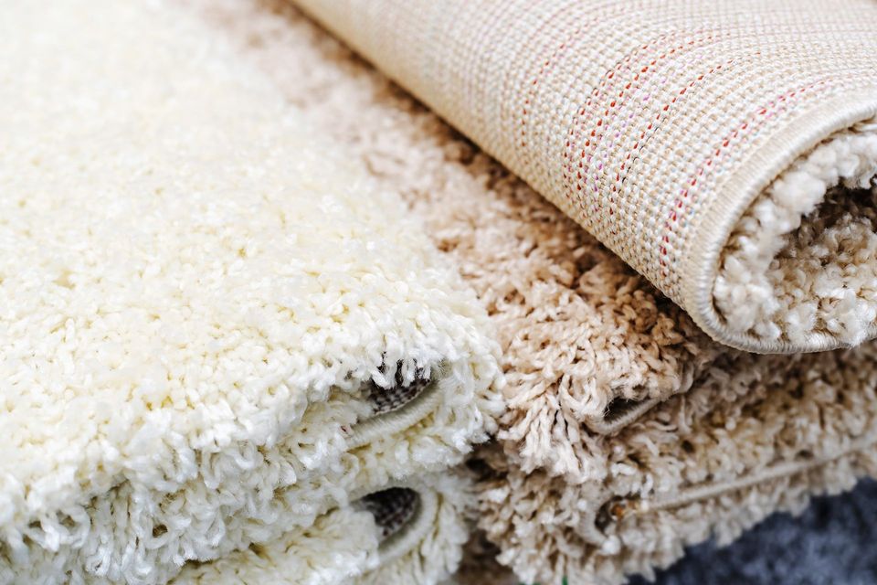 Different Types of Rugs Stacked on Top of Each Other