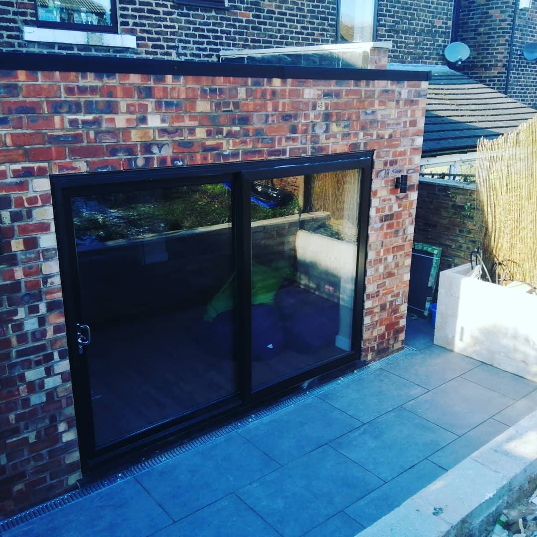 A brick building with a sliding glass door