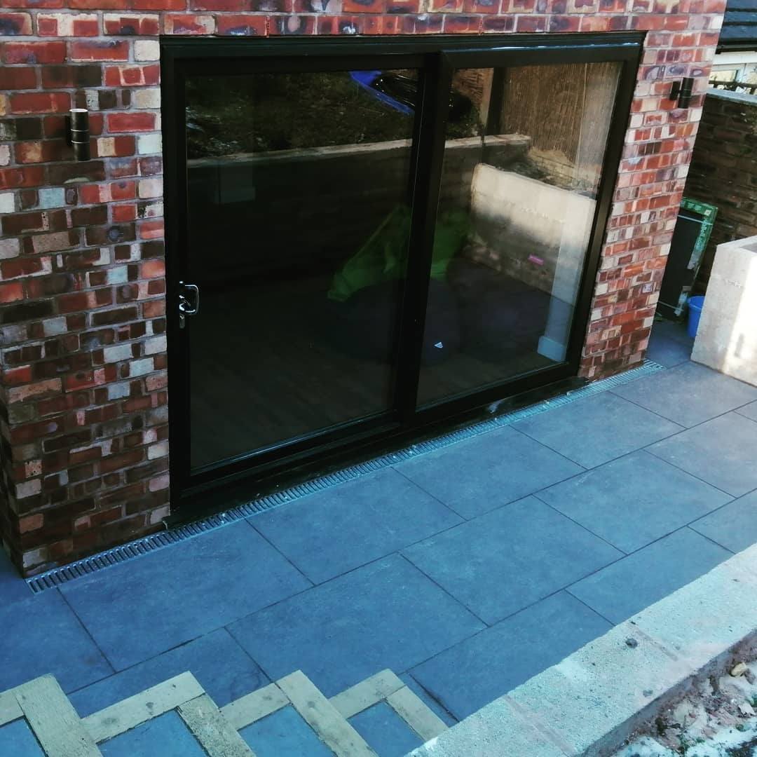 A brick building with a sliding glass door