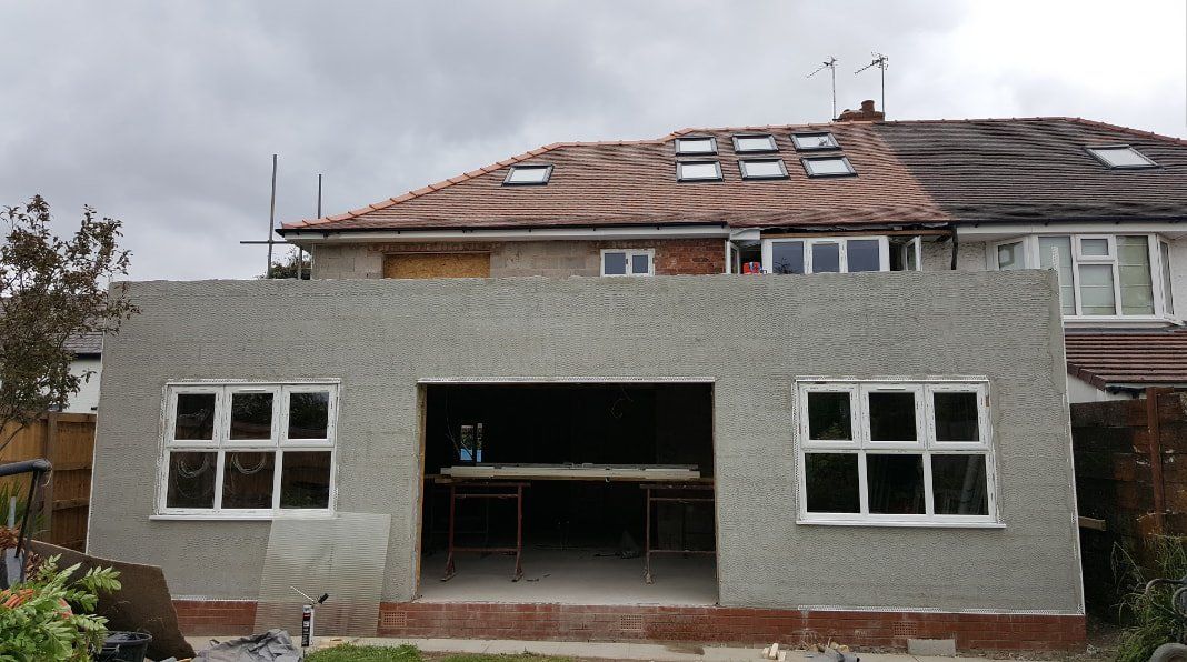 A house with a roof that is being built with a lot of windows.