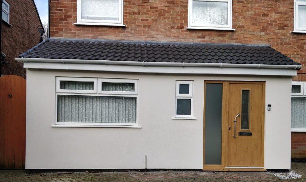 A house with a roof extension and a wooden door.