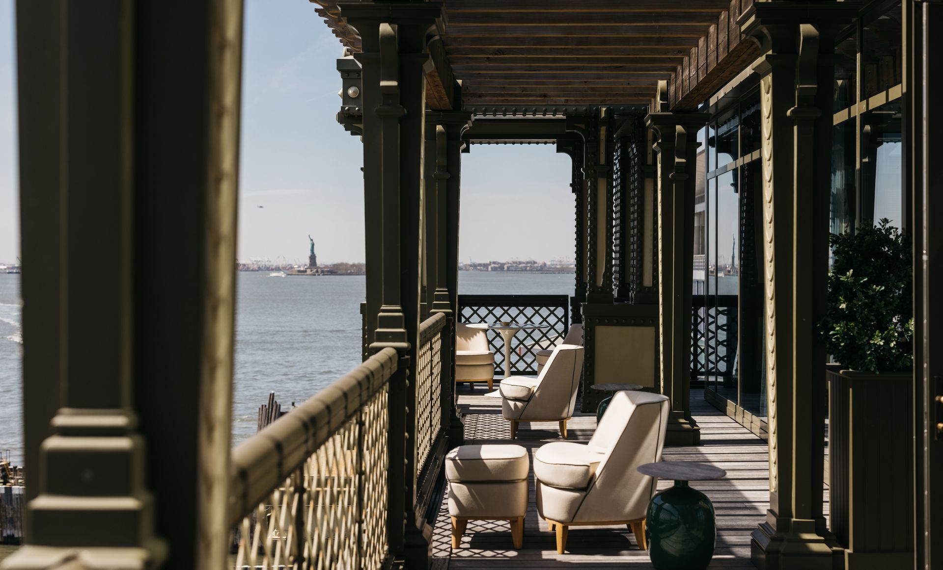 A porch with a view of the statue of liberty