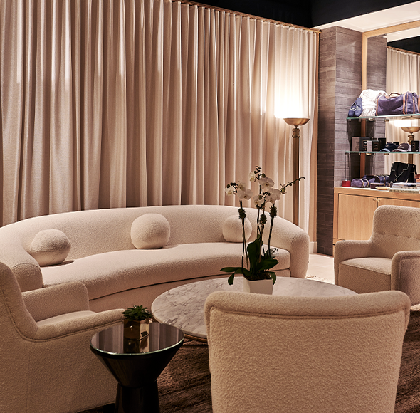 A living room with a curved couch and chairs