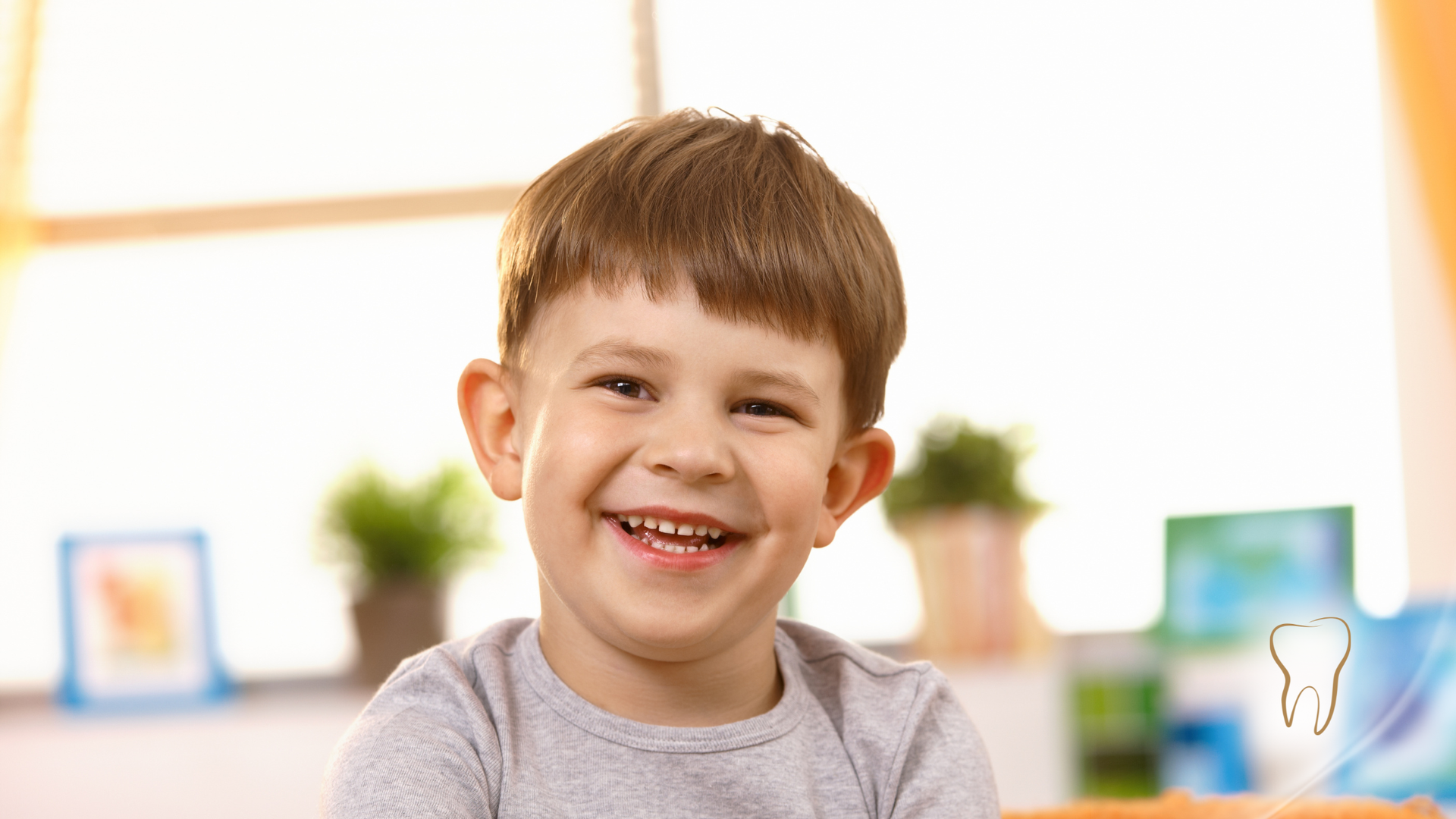 Smiling child indoors. Bright setting with plants and a window.
