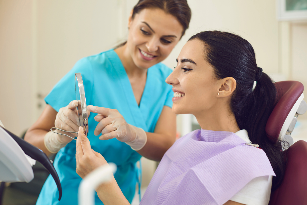 Two men in scrubs are posing for a picture in a waiting room.