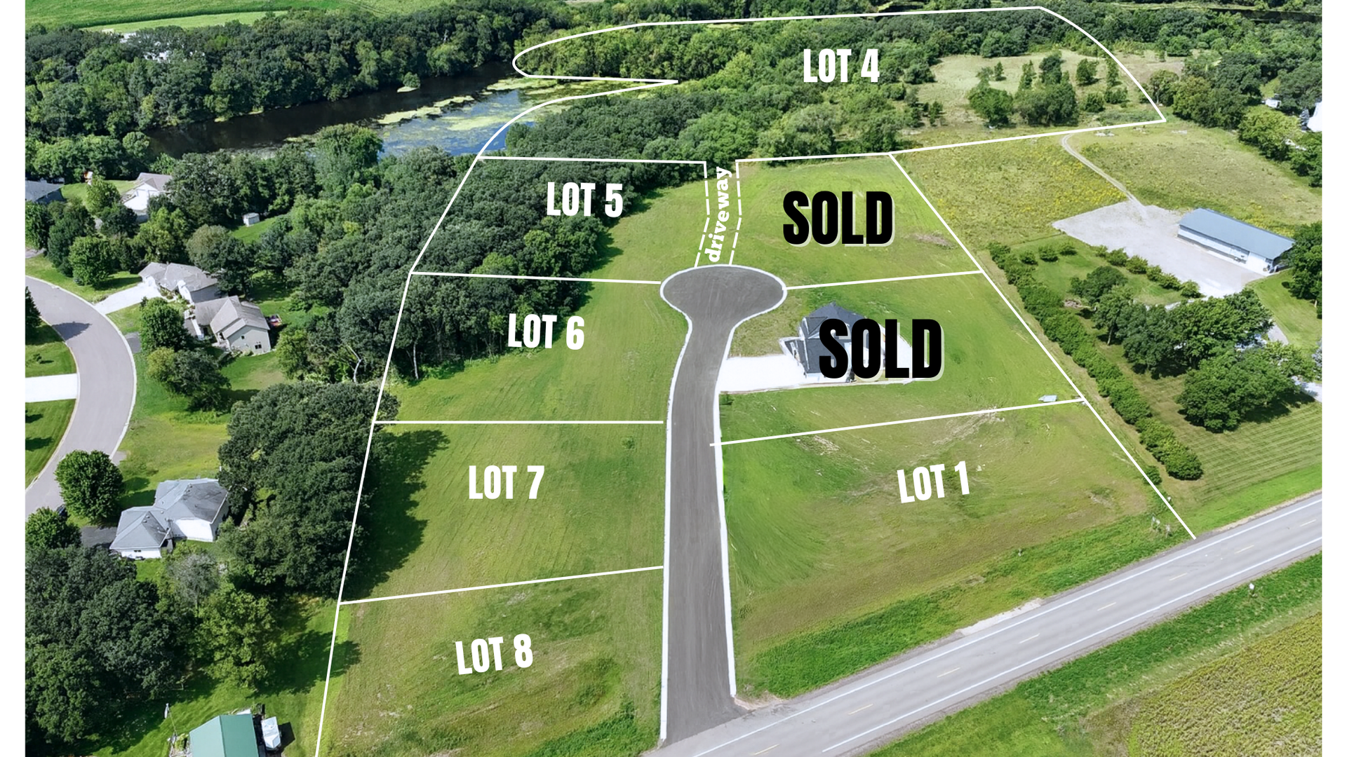 Aerial view of a residential lot with labeled sold lots, road, trees, and a building on the right.