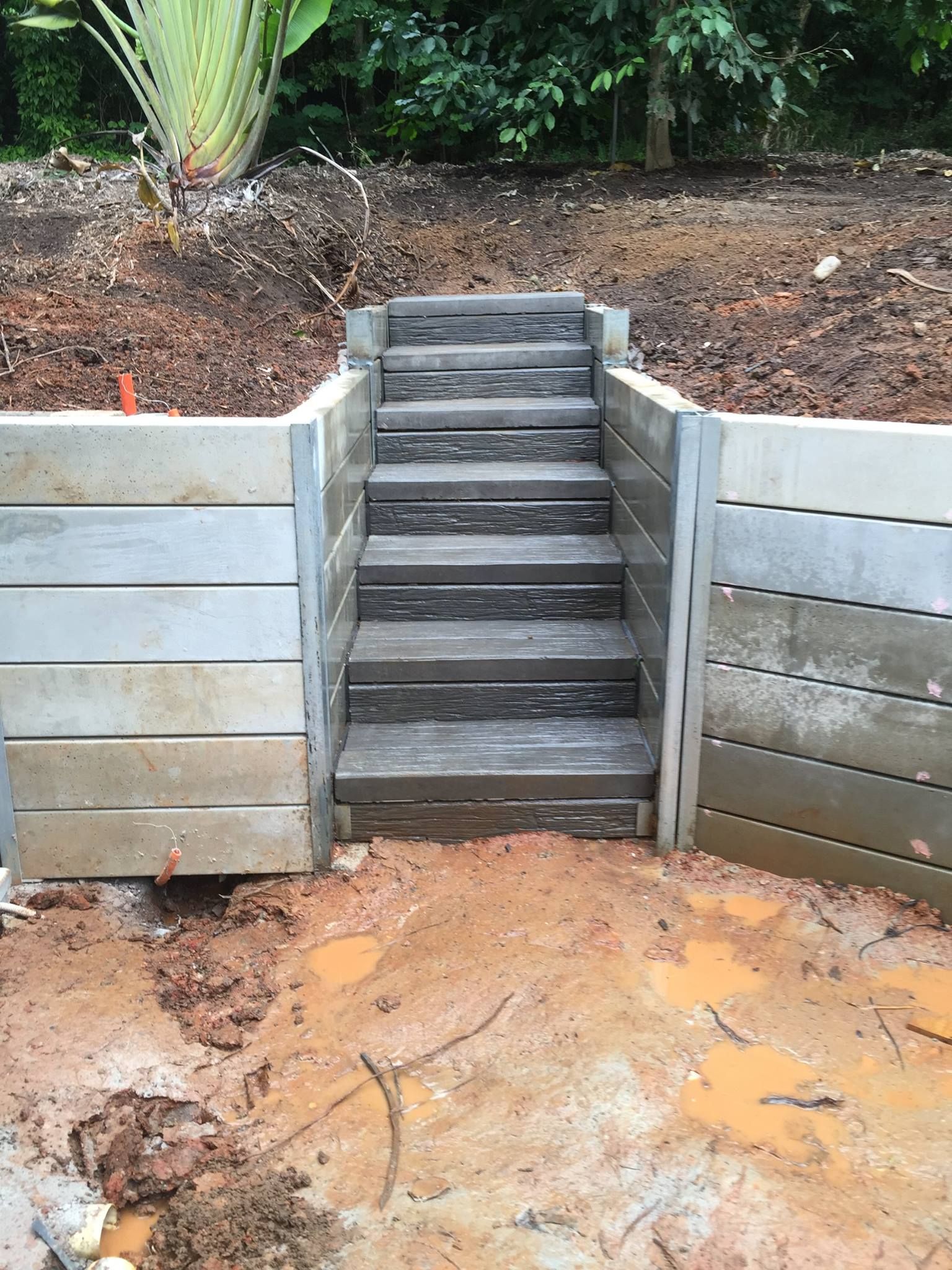 Concrete Retaining Wall With Wooden Steps — NQ Prefab Concrete Products Pty Ltd in Mission Beach, QLD