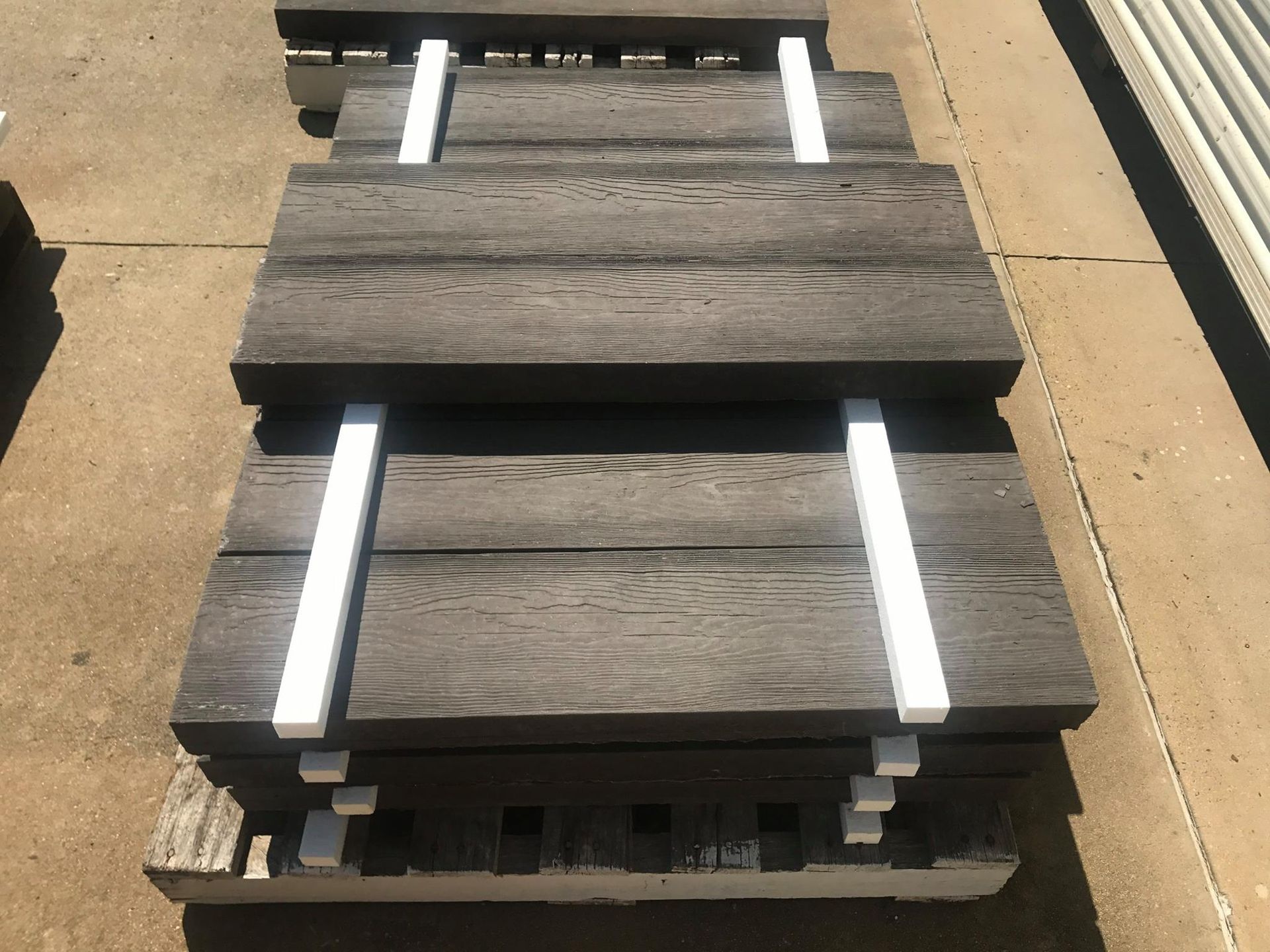 Stack of Gray Composite Deck Boards — NQ Prefab Concrete Products Pty Ltd in Coconuts, QLD