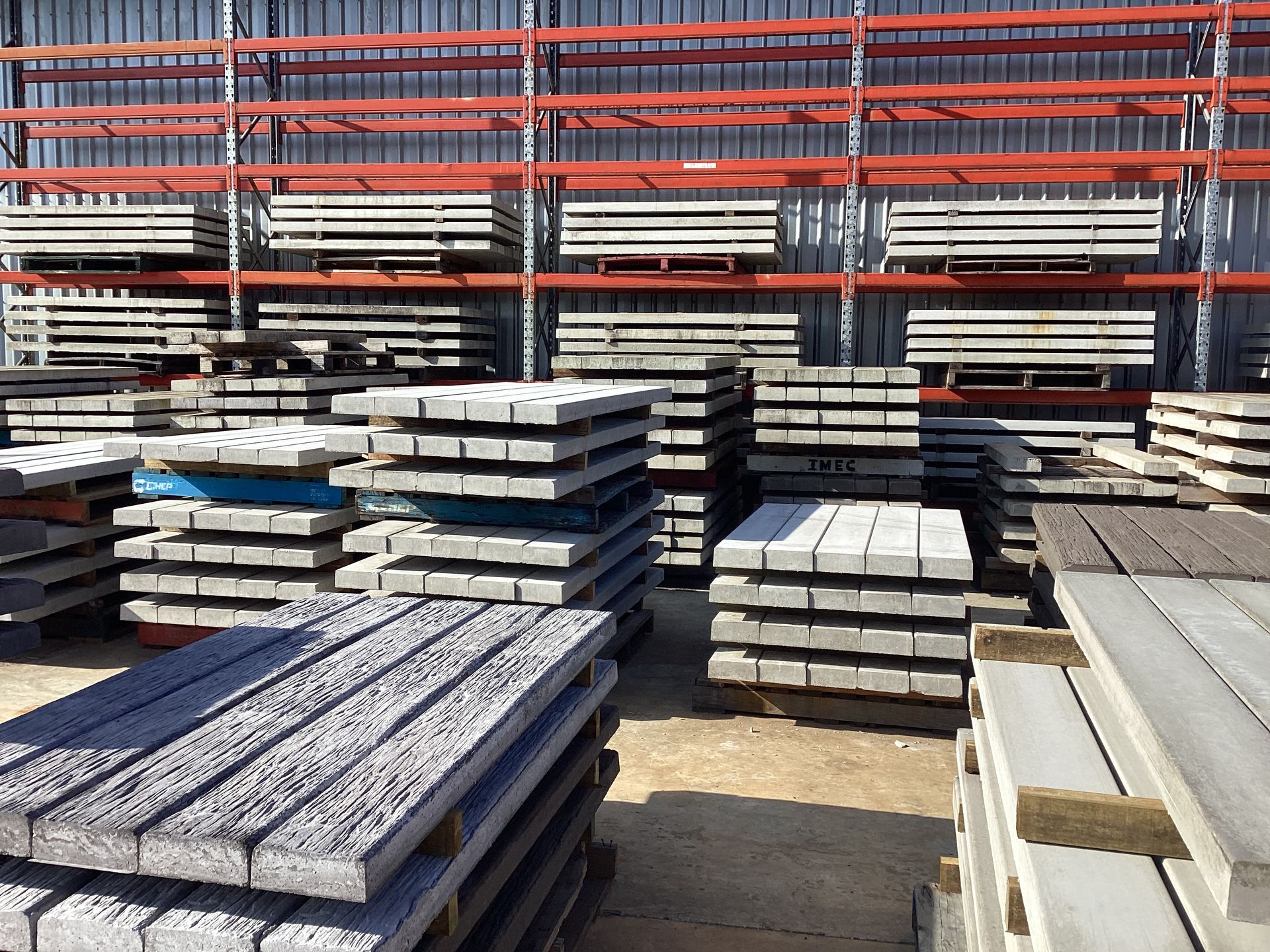 Stacks of Gray Concrete Fence Panels in an Outdoor Storage Area — NQ Prefab Concrete Products Pty Ltd in Coconuts, QLD