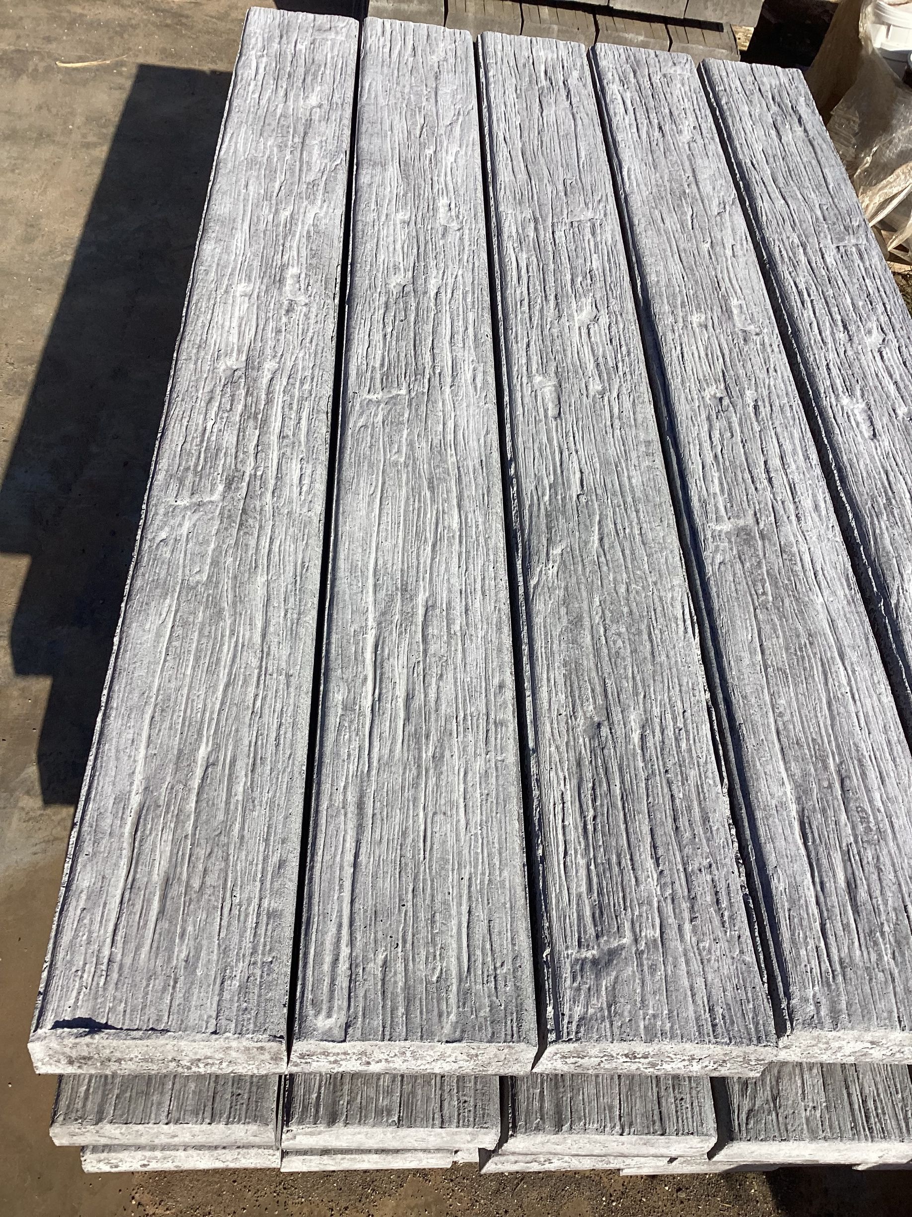 Stack of Weathered, Gray Wooden Planks With Linear Grain — NQ Prefab Concrete Products Pty Ltd in Coconuts, QLD
