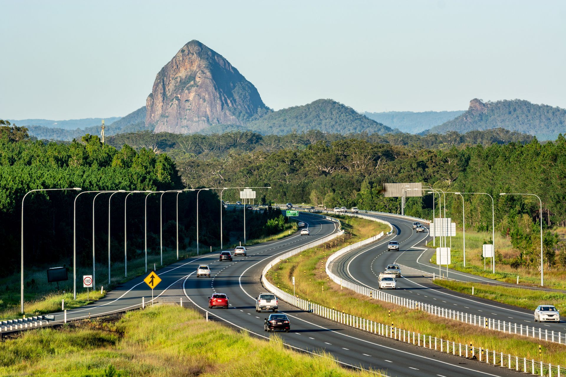 Highway Winds Past Mountains, Cars Traveling; Sunny Day — Adamson Town Planning in Noosaville, QLD