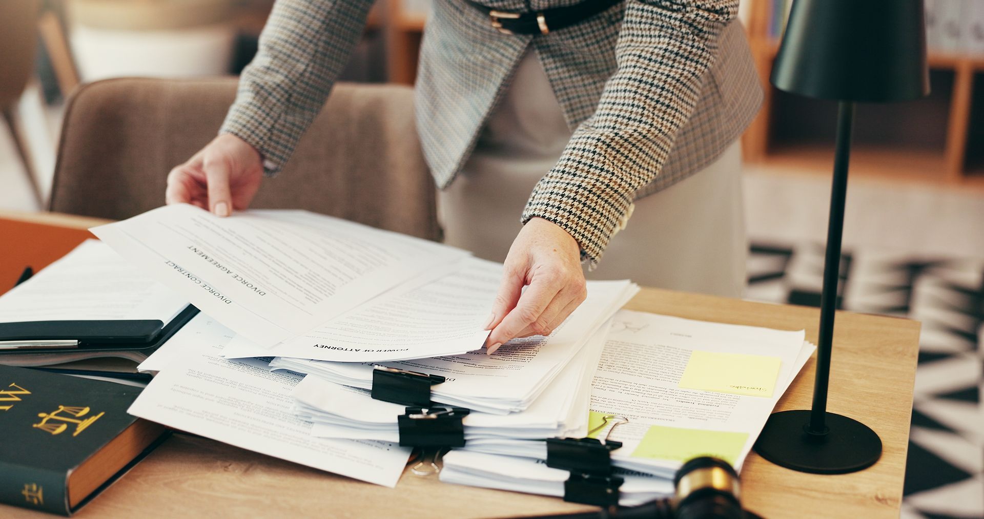 Two People at a Desk Review Documents; Scales of Justice and Gavel Sit Nearby — Adamson Town Planning in Noosaville, QLD