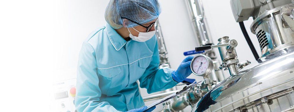 A scientist is working on a machine in a laboratory.