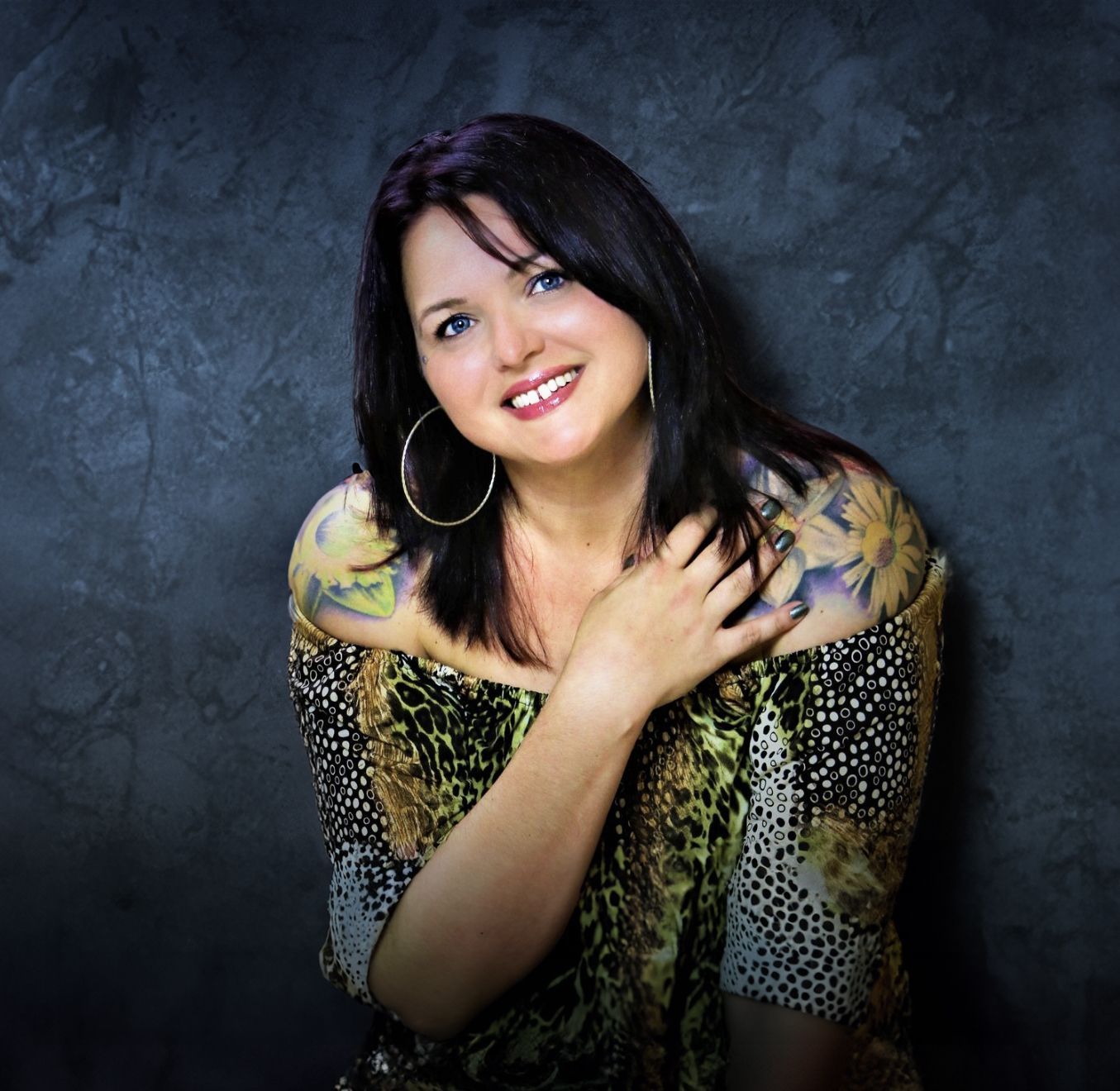 Beth Snyder, certified newborn photography instructor in Mokena, Illinois, smiling in studio portrait