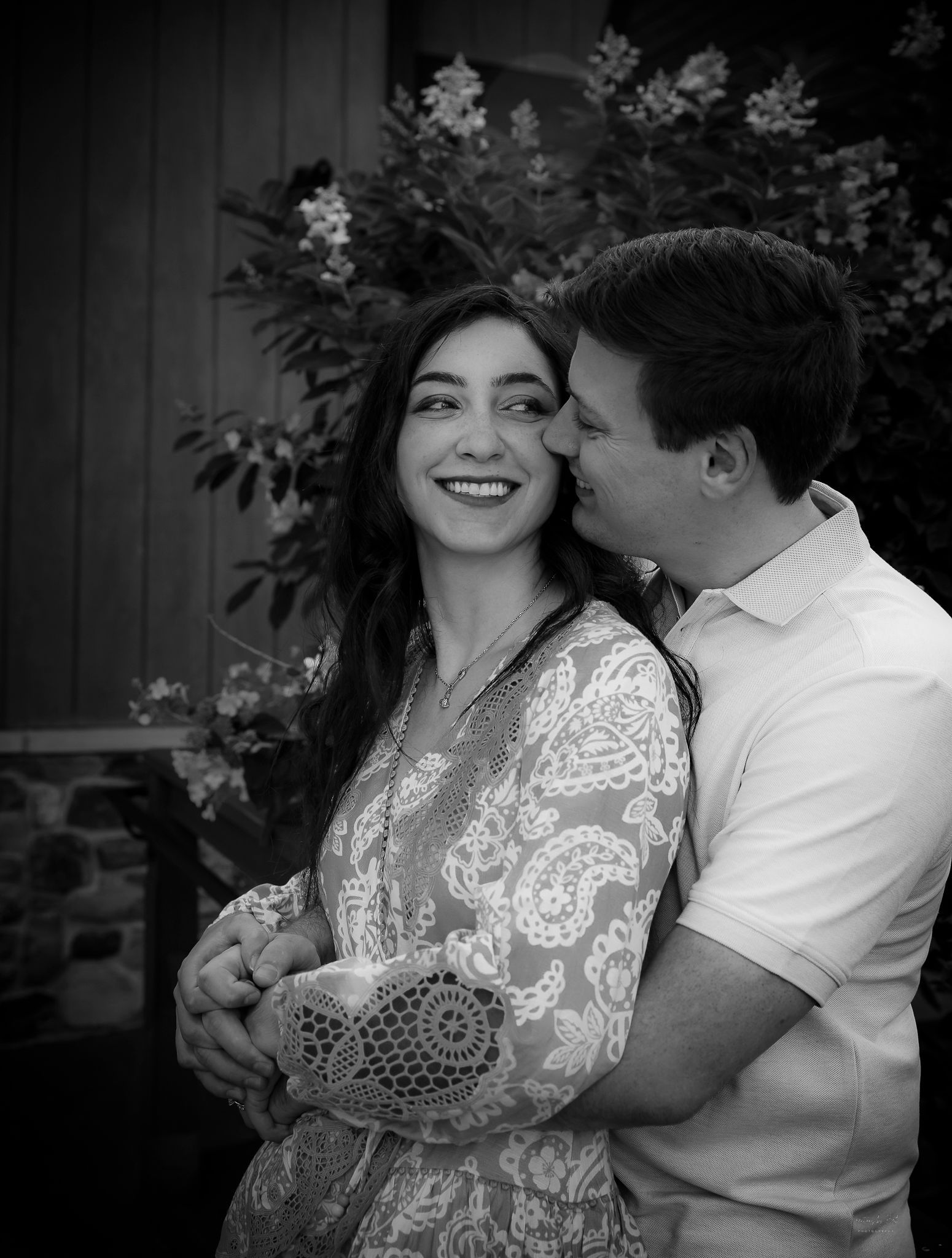 black and white portrait couple near flowering bush