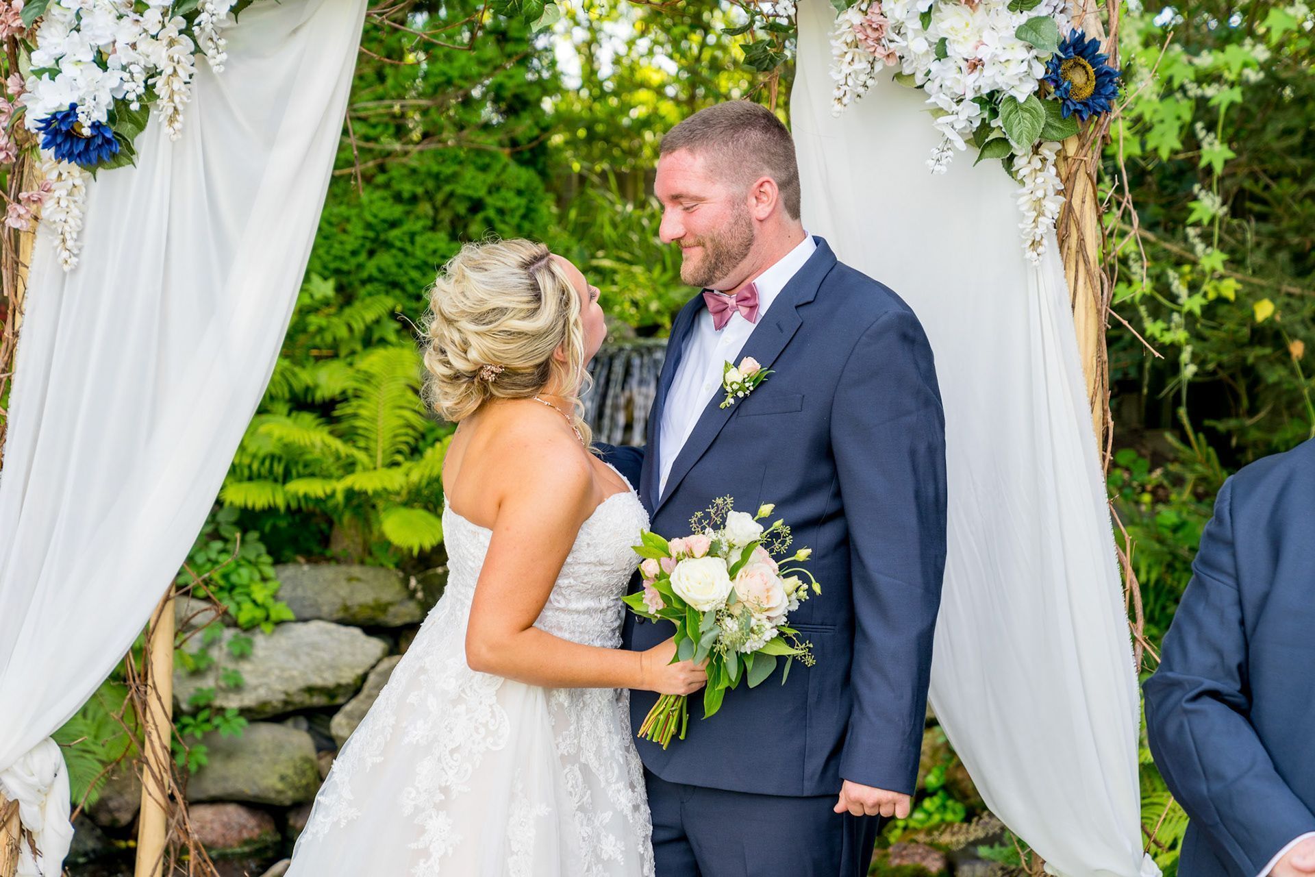 bride and groom decorated with flowers and fabric background