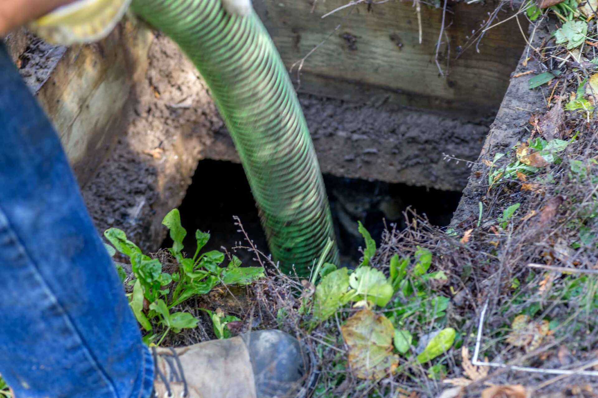 Worker Emptying A Septic Tank — Wilmington, NC — Skipper Septic Tank Service