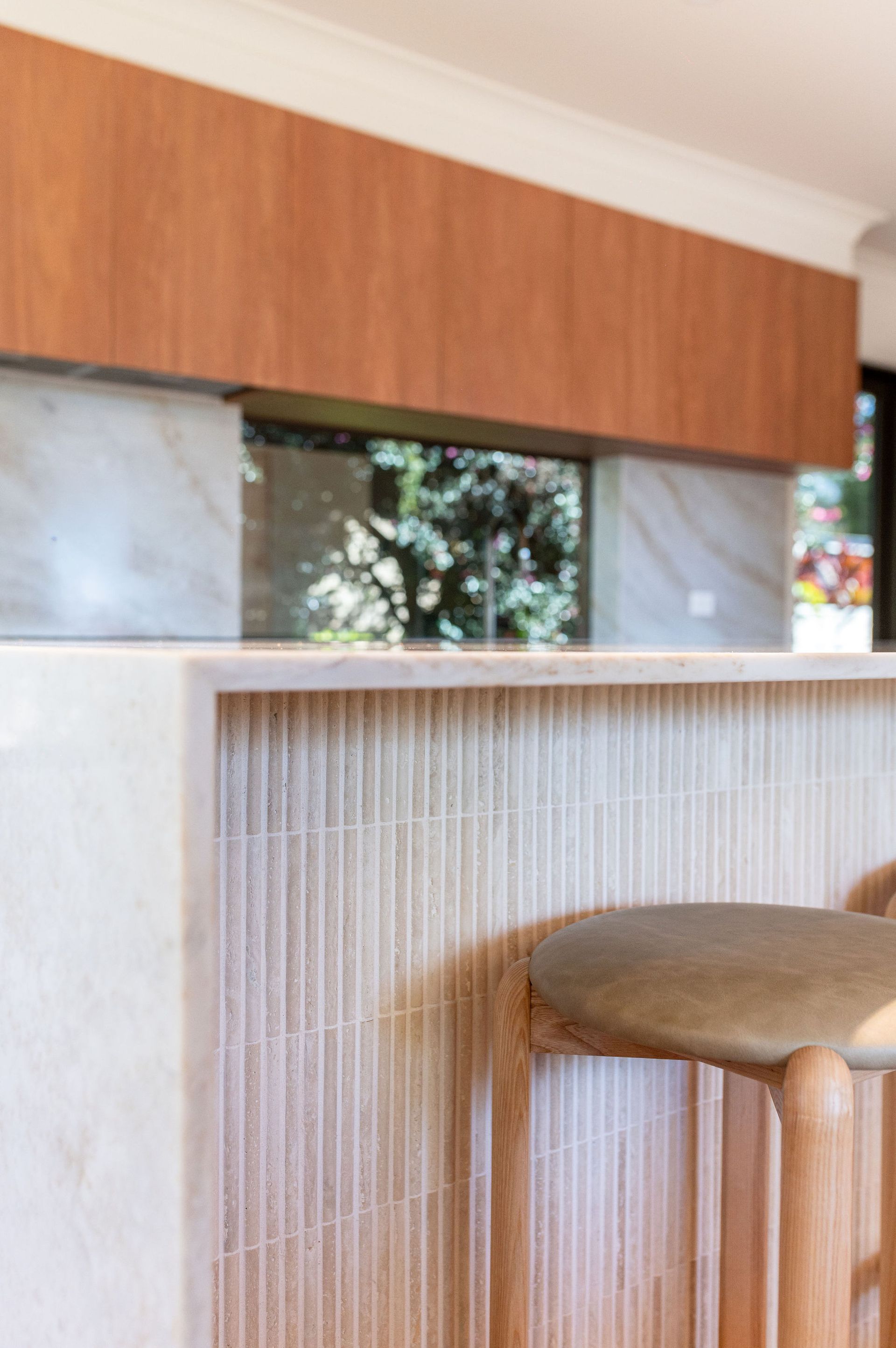 A kitchen with white cabinets and a black counter top — Flow Kitchens in Taree South, NSW