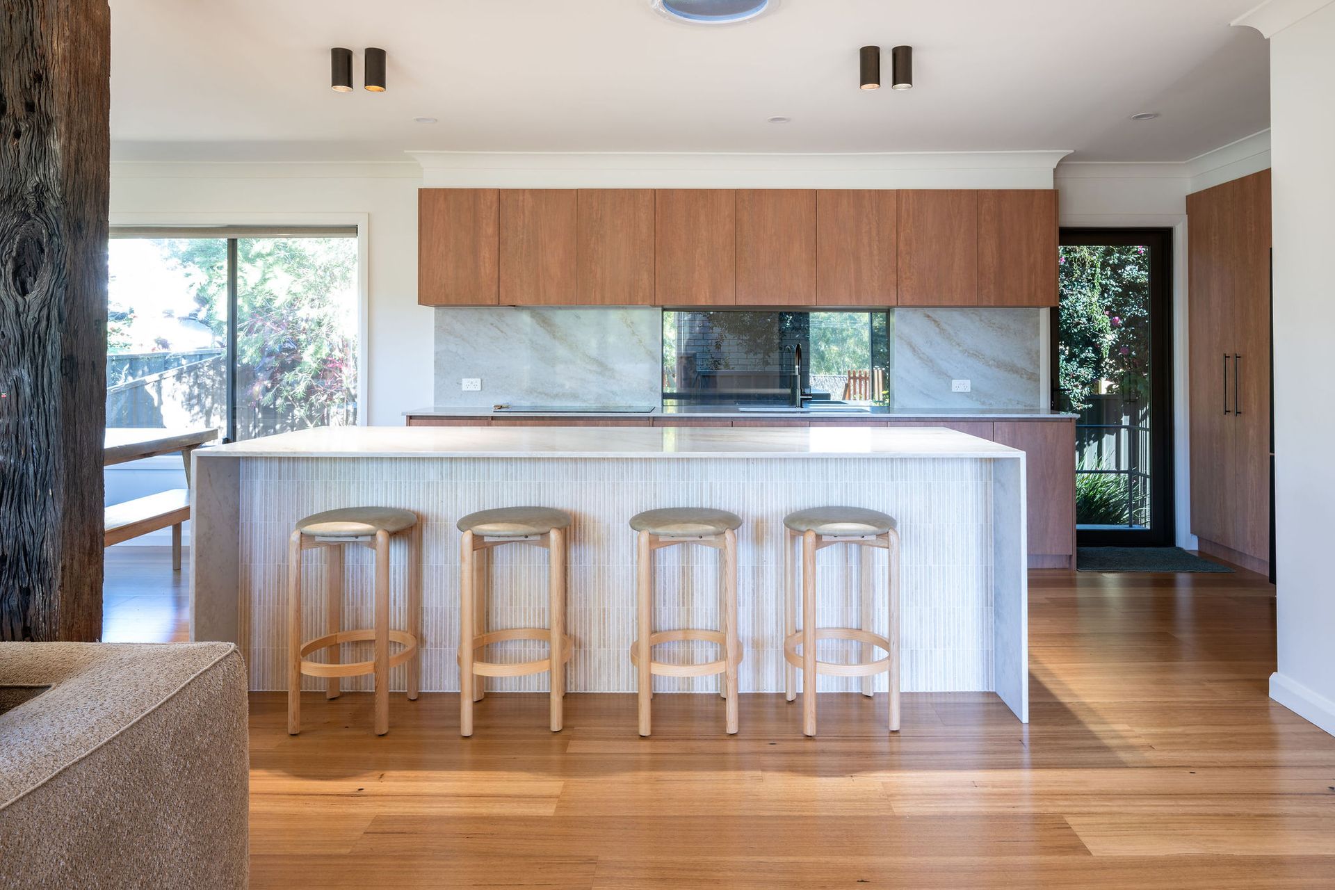 Kitchen With Wooden Countertop, White Cabinets, and Large Windows Overlooking a Scenic View — Flow Kitchens in Taree South, NSW