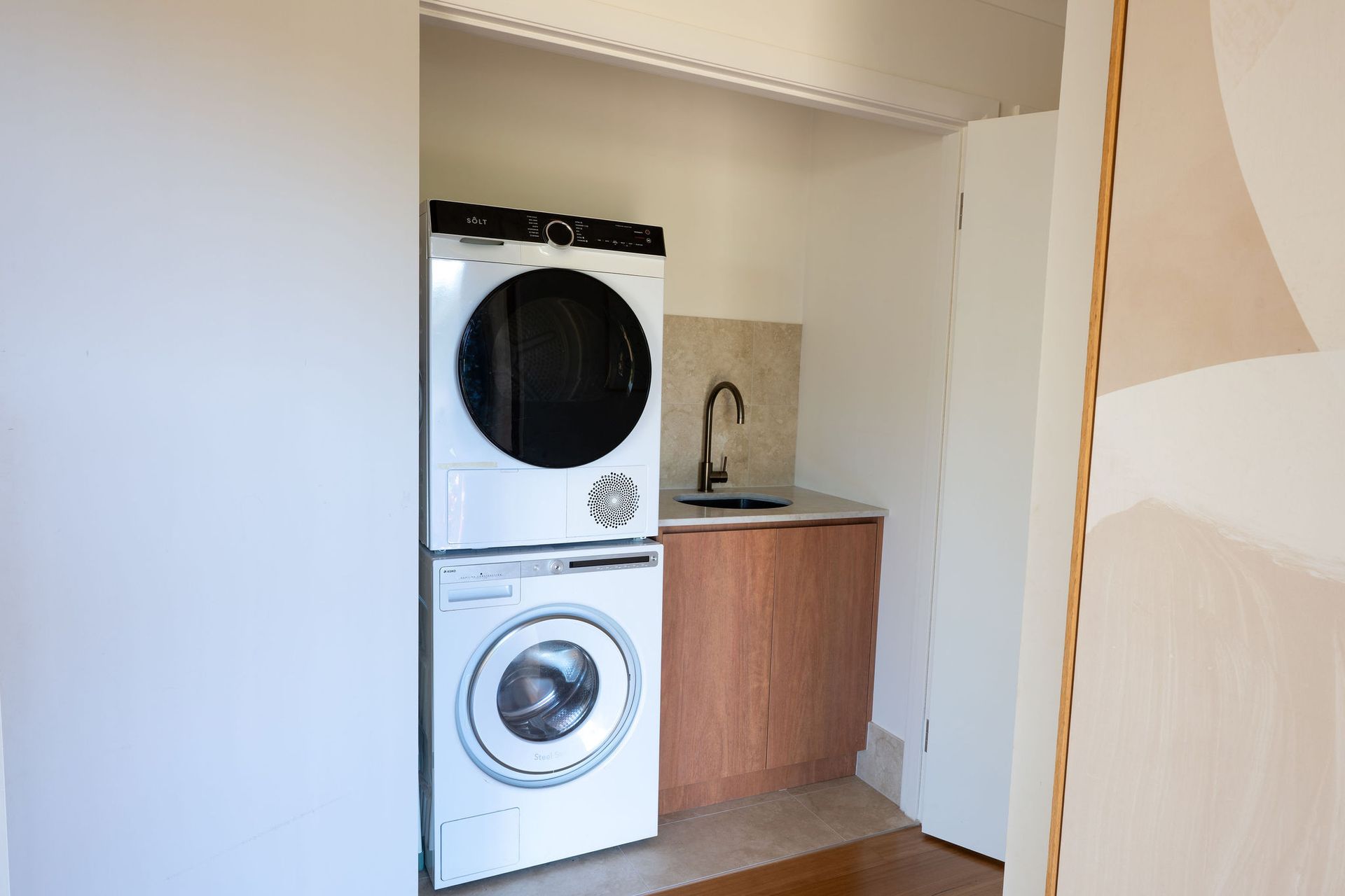 A Laundry Room With a Washer and Dryer and a Sink — Flow Kitchens in Taree South, NSW