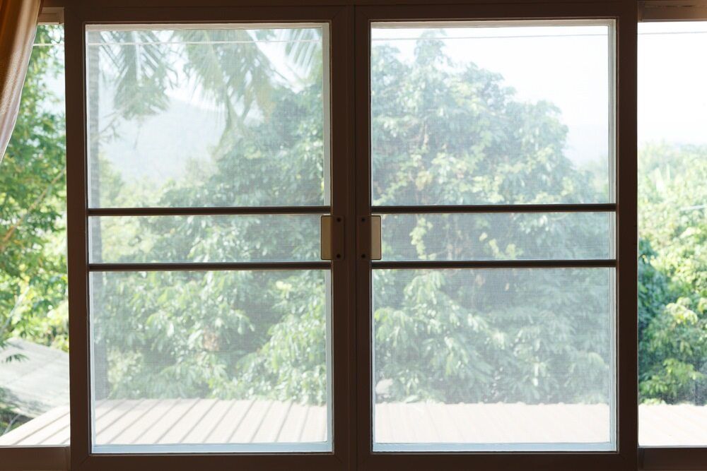 A Window With a View of Trees and a Wooden Deck — Flow Kitchens in Taree South, NSW