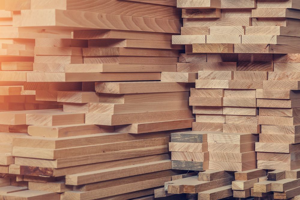 A Pile of Wood is Stacked on Top of Each Other — Flow Kitchens in Forster, NSW