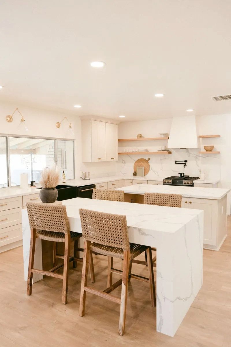 A Kitchen With a Large Island, a Table and Chairs — Flow Kitchens in Taree South, NSW