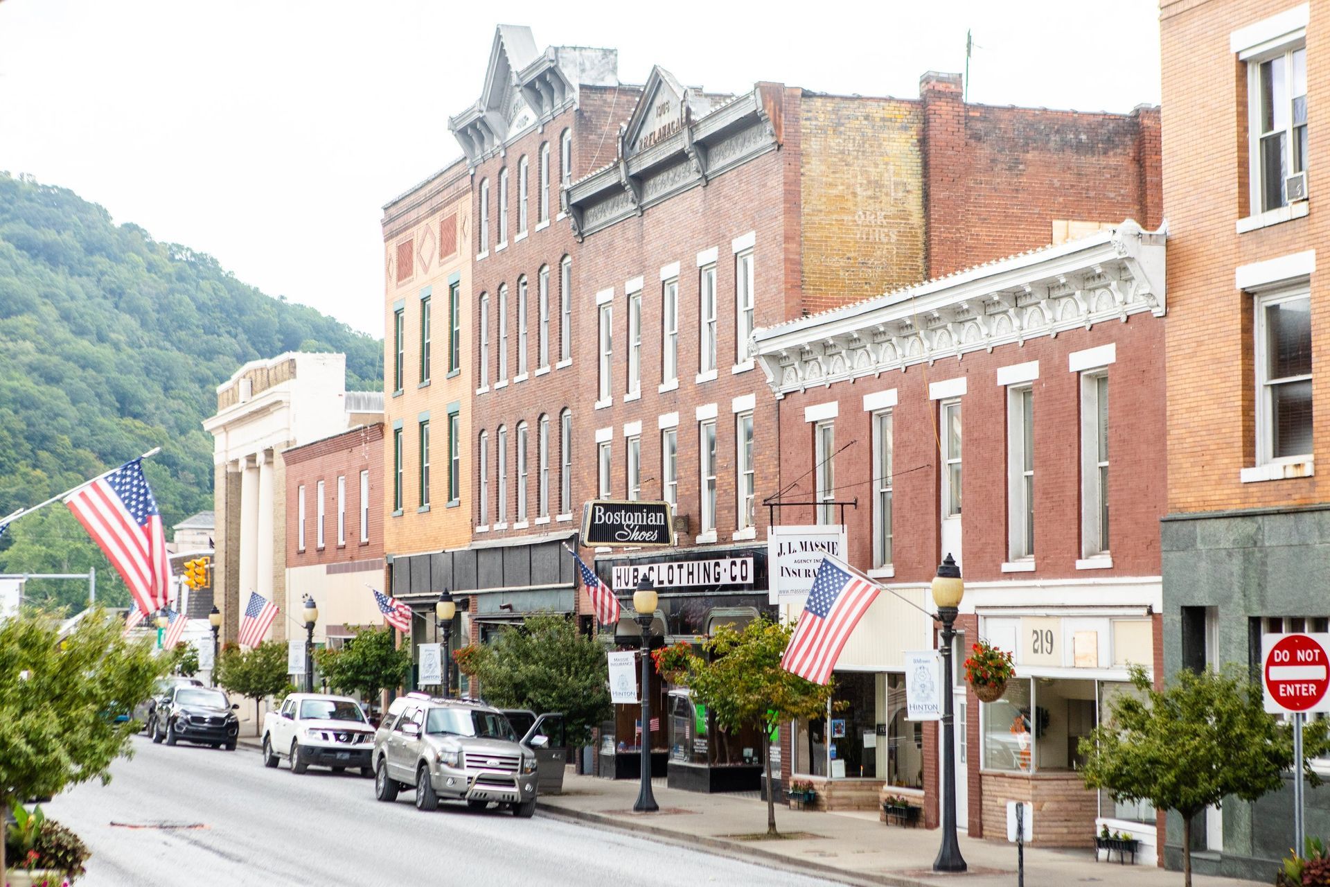A small town with a lot of buildings and a stop sign on the side of the road.