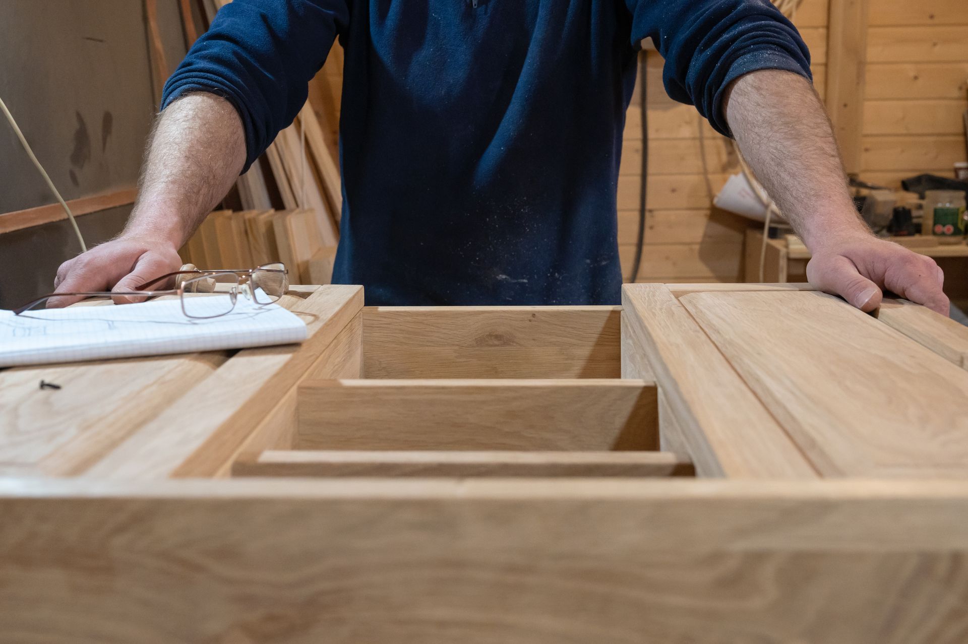 Close-up of a master carpenter's hands crafting a handmade cabinet