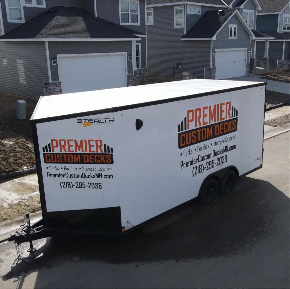 A white enclosed utility trailer branded with