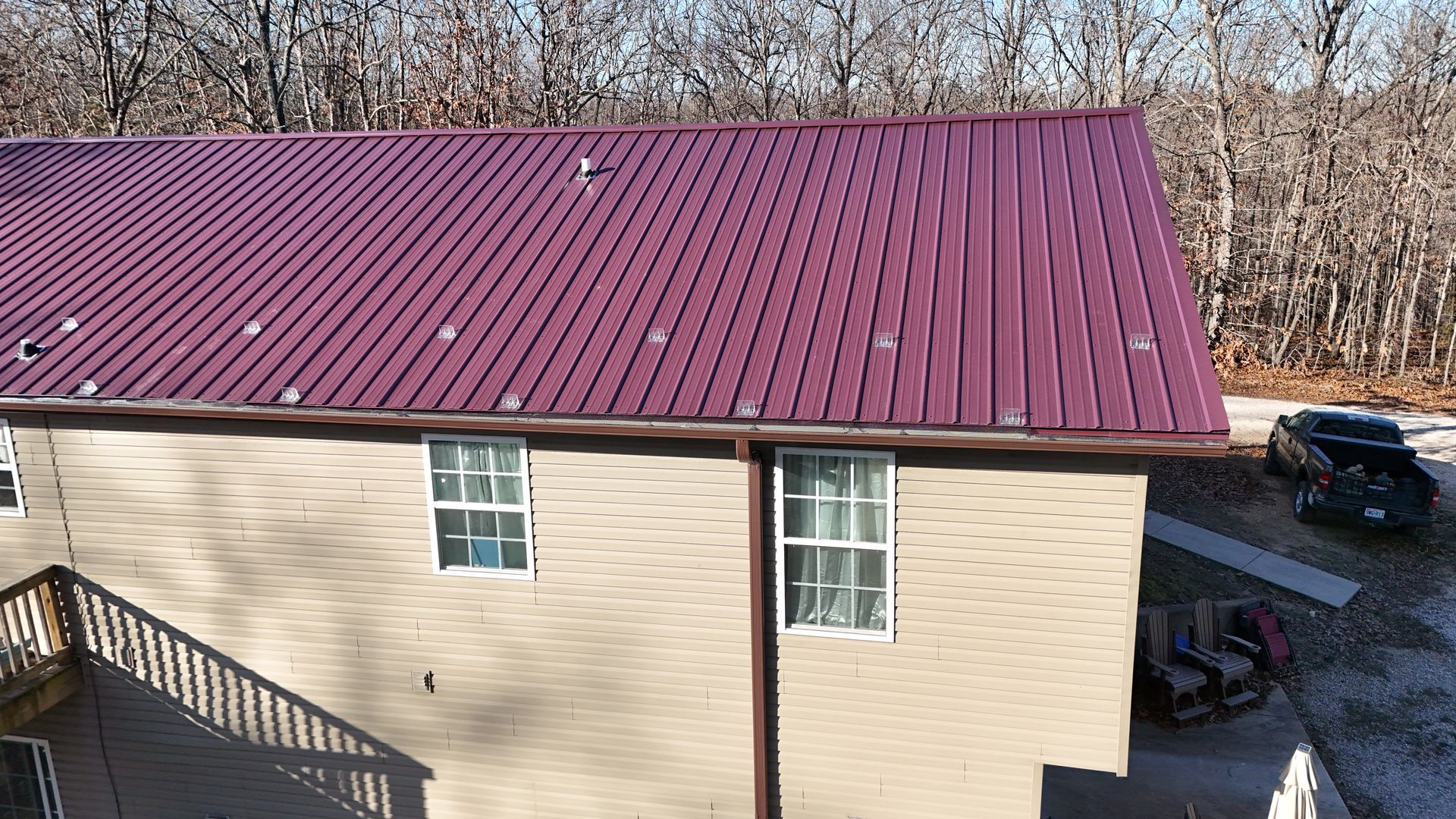 A roof with a fan on top of it and a blue sky in the background | Roofing company in springfield mo