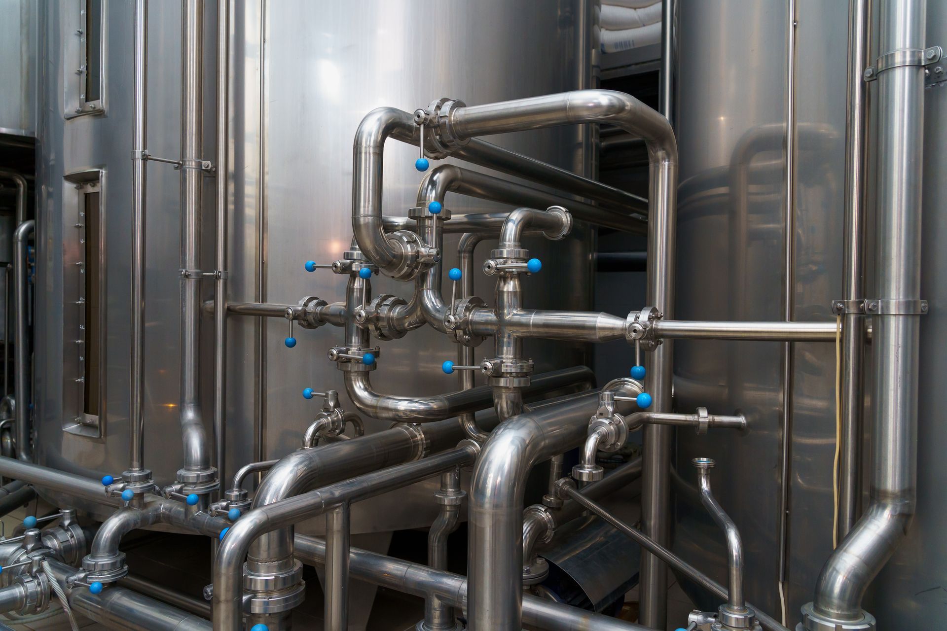 Stainless steel industrial pipes and valves in a metallic processing facility