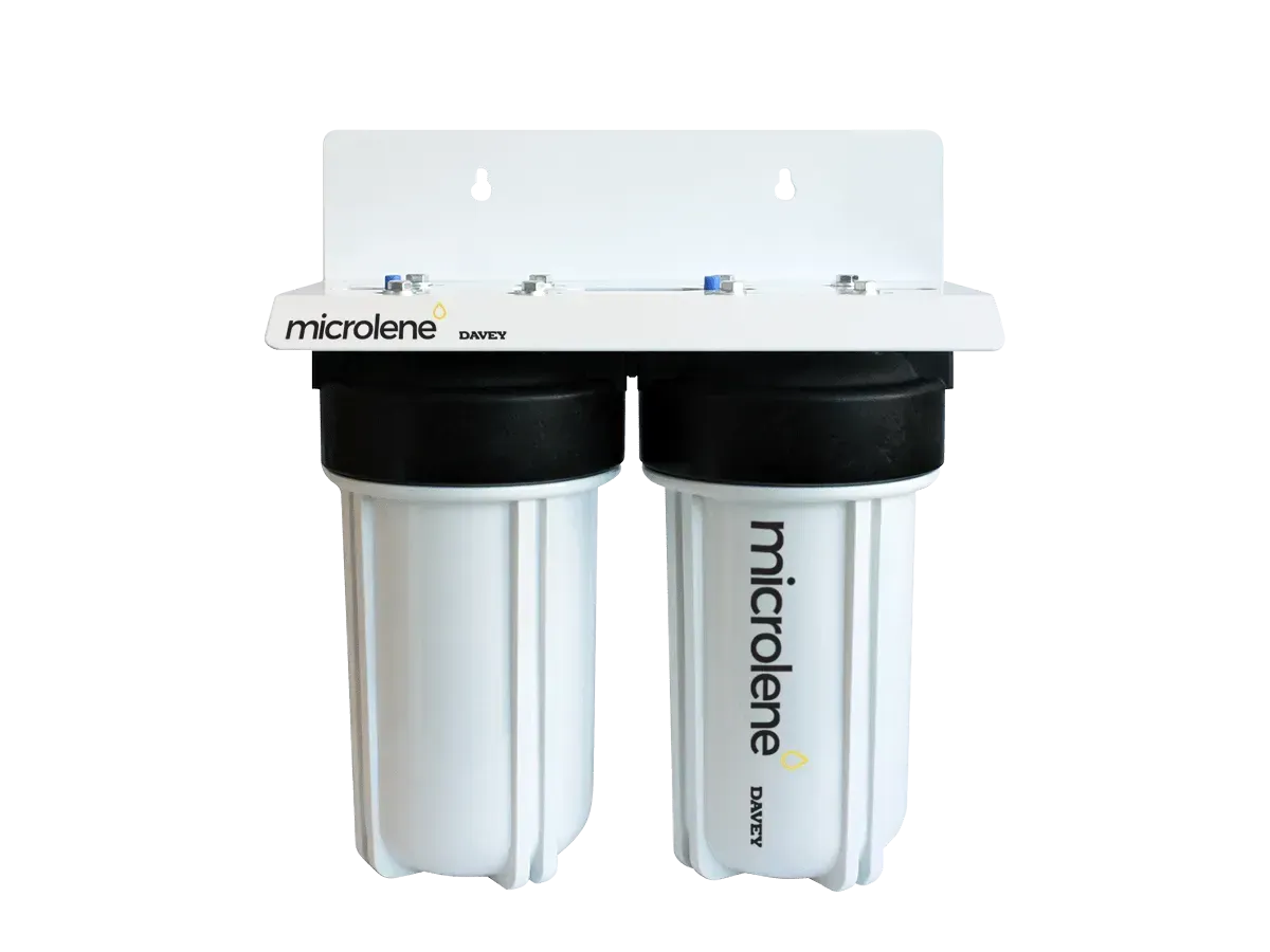 White wall-mounted double water filter with two black canisters and a white top bracket