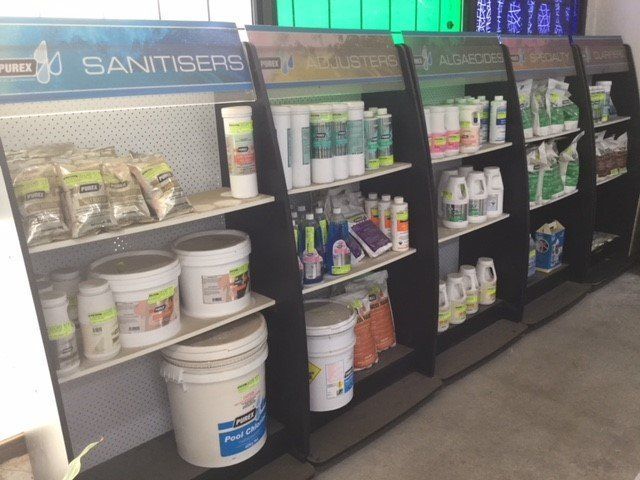 Store shelf of sanitiser and cleaning supplies in black display racks